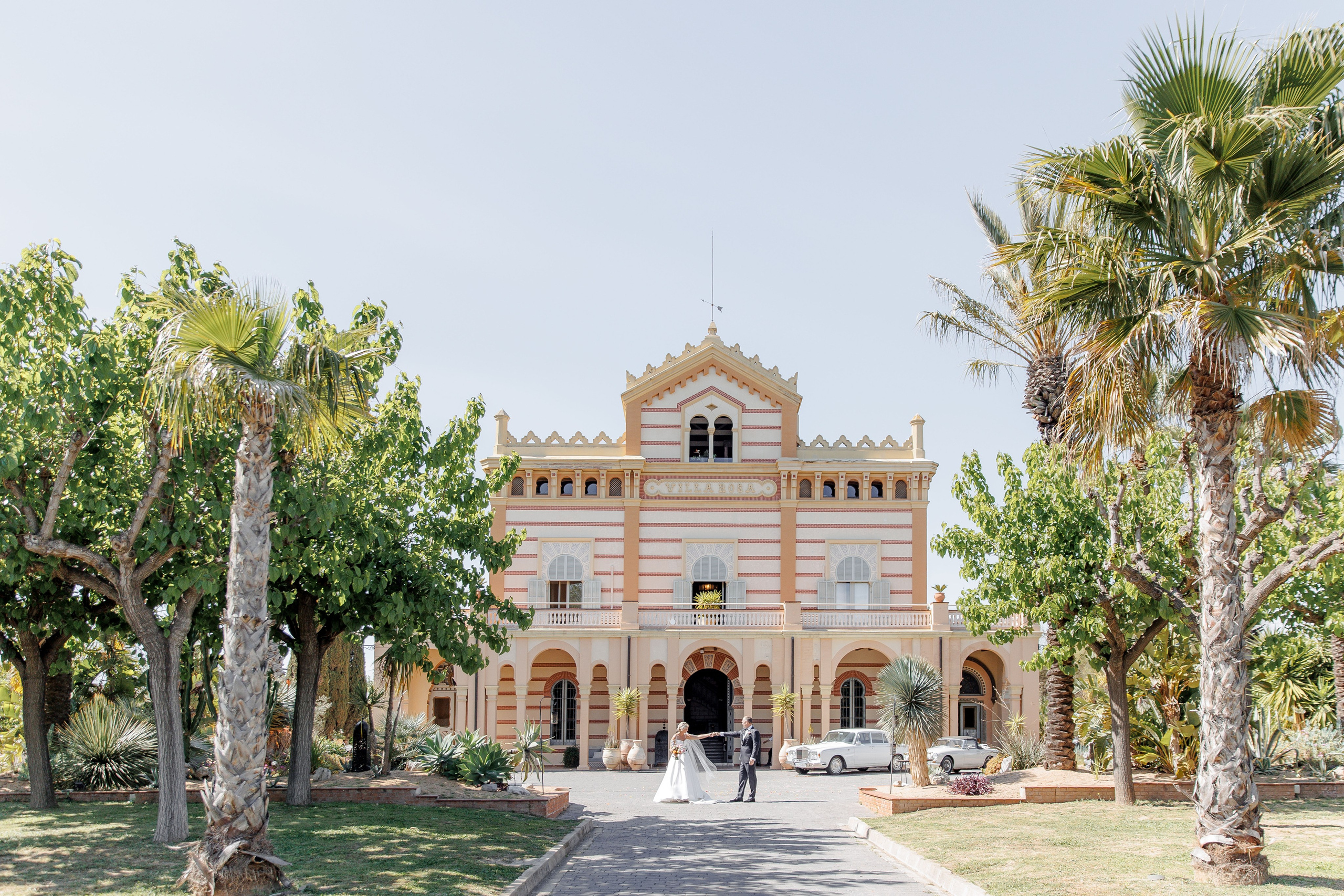 Stunning wedding venue in Europe, ideal for destination weddings, captured beautifully with the groom and bride dancing in front of the villa.
