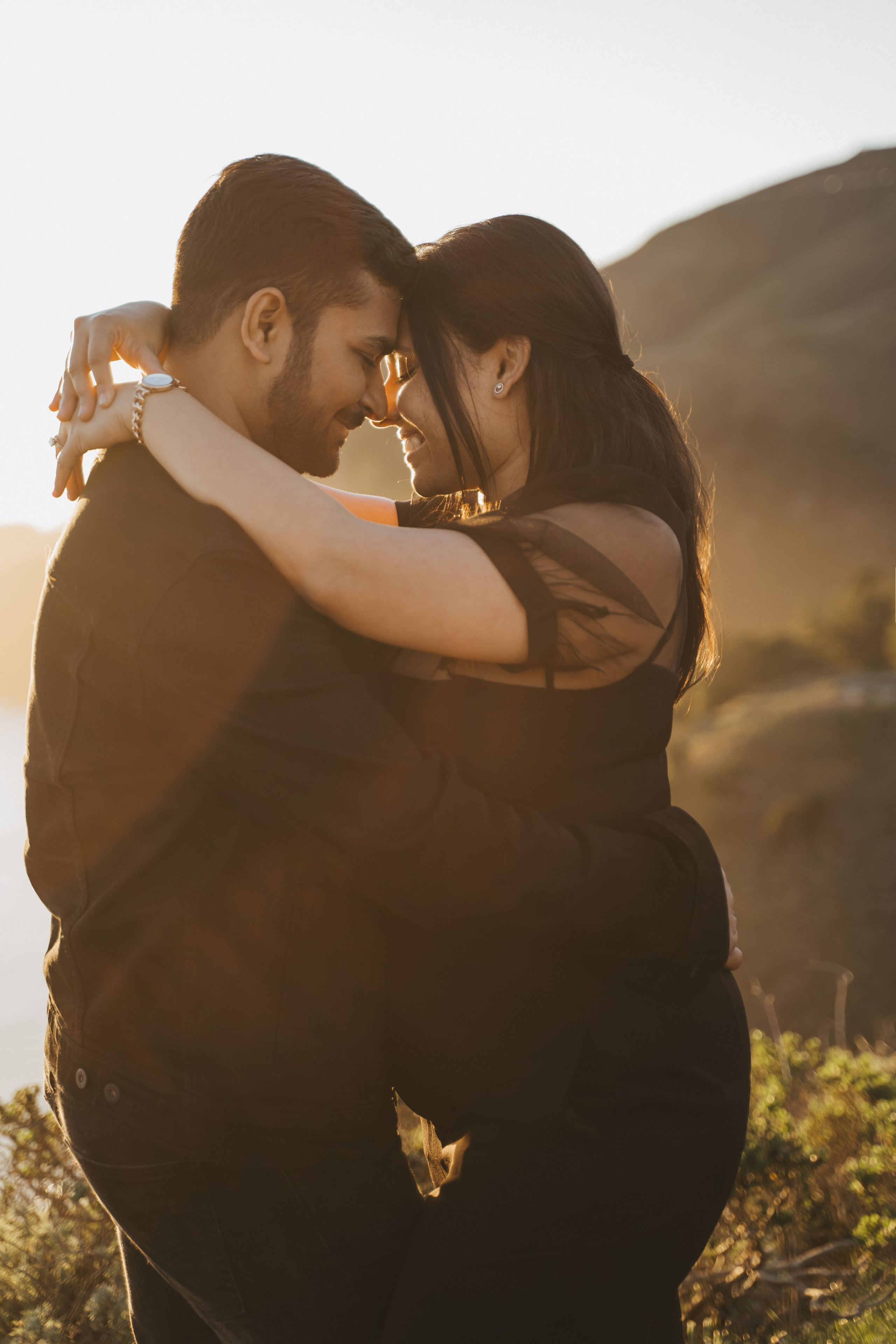 Proposal.  Overlooking the golden San Franisco Bridge sunset with a couple. Photographer Video. 