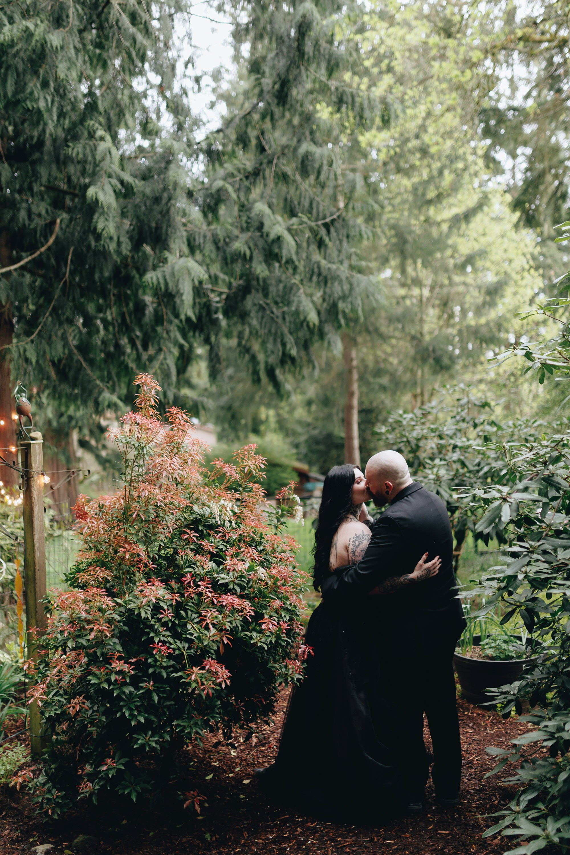 Bride and groom embracing in forest, intimate wedding portrait