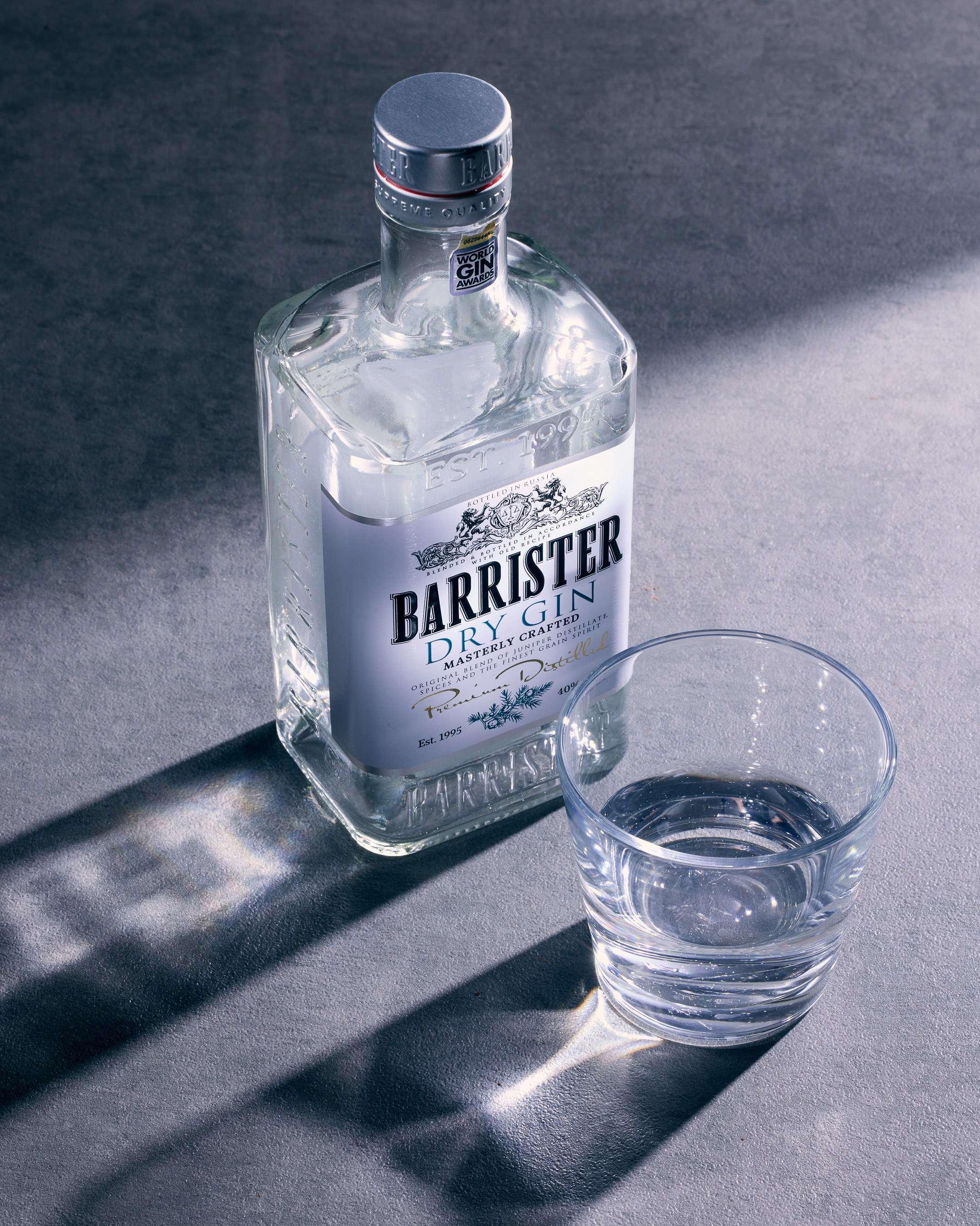Barrister gin bottle and glass on grey background - photographer Andrey Dunin