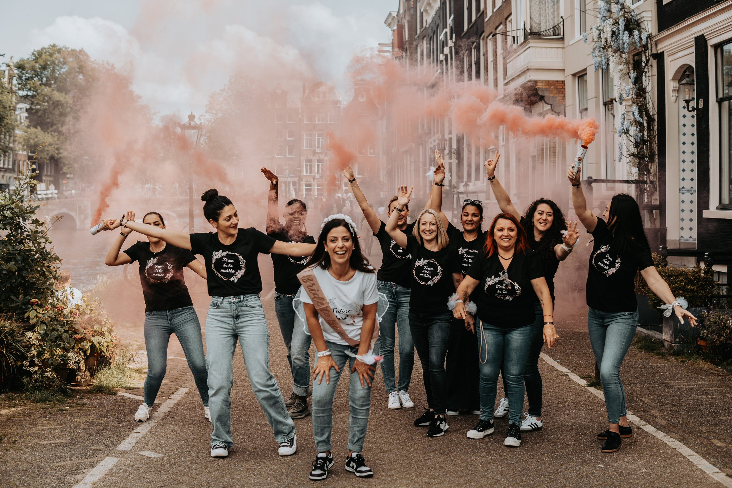 girls popping color smokes in a bachelorette party