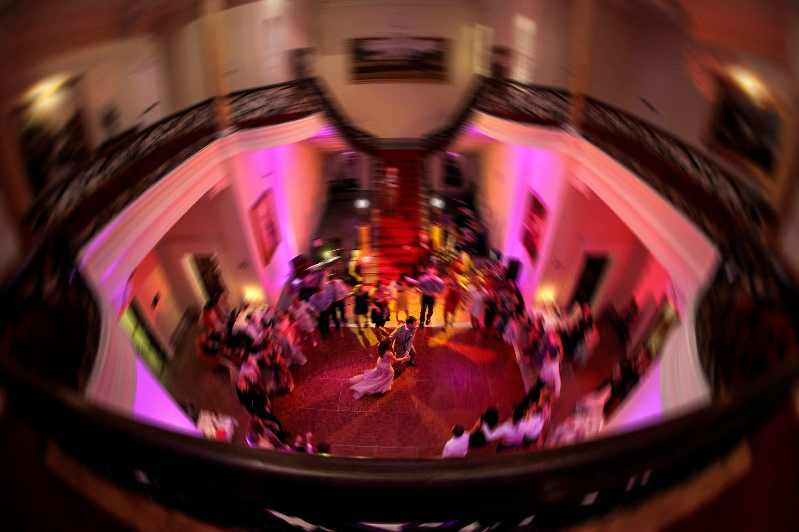Aerial view of Irish newlyweds dancing on colorful floor at Middleton Park House, Ireland.