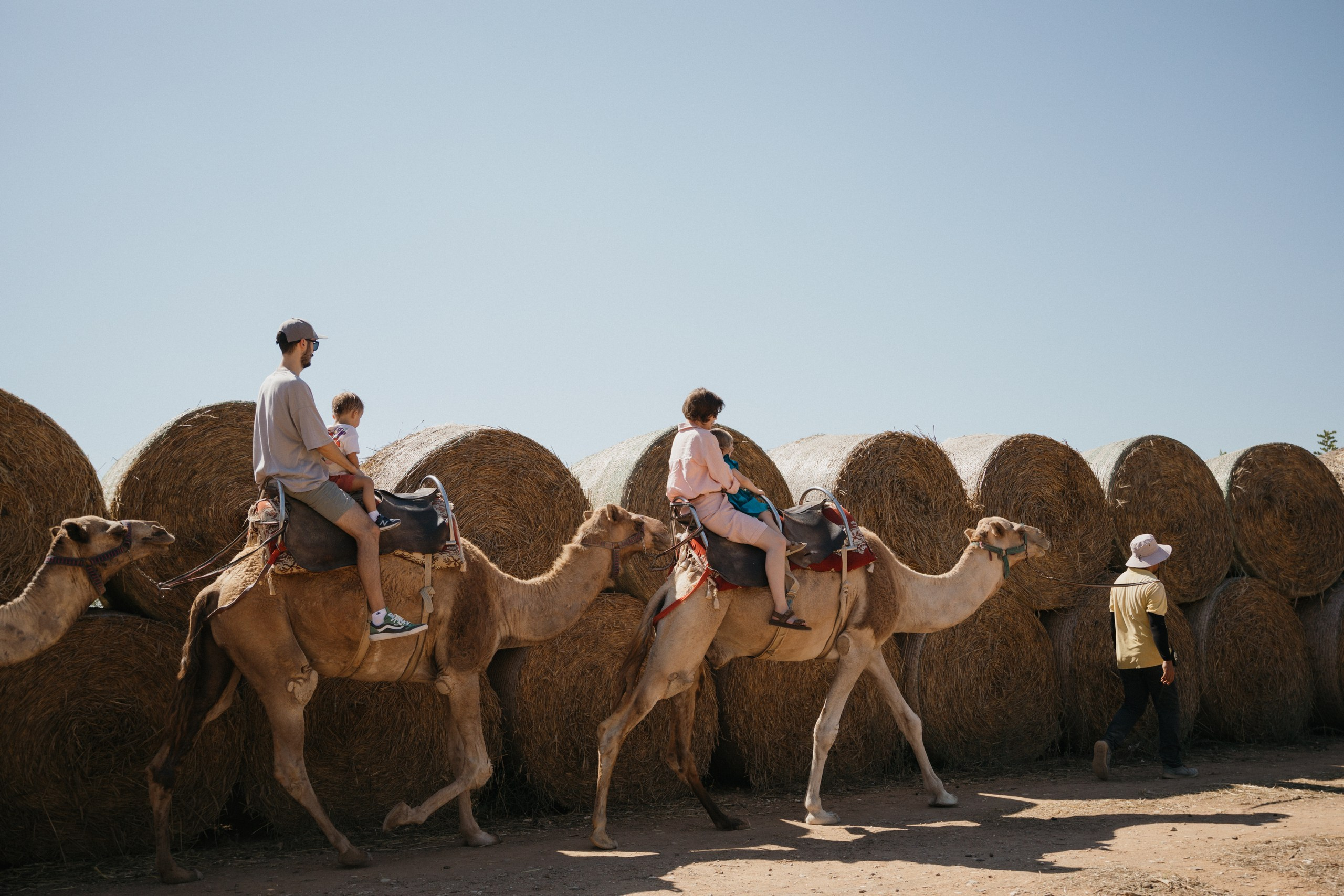 Joyful Moments in Camel park: Olya and Ada’s Day of Fun and Adventure, sliding and riding camels. Photographer in Barcelona capturing unique stories | Kate Chumak
