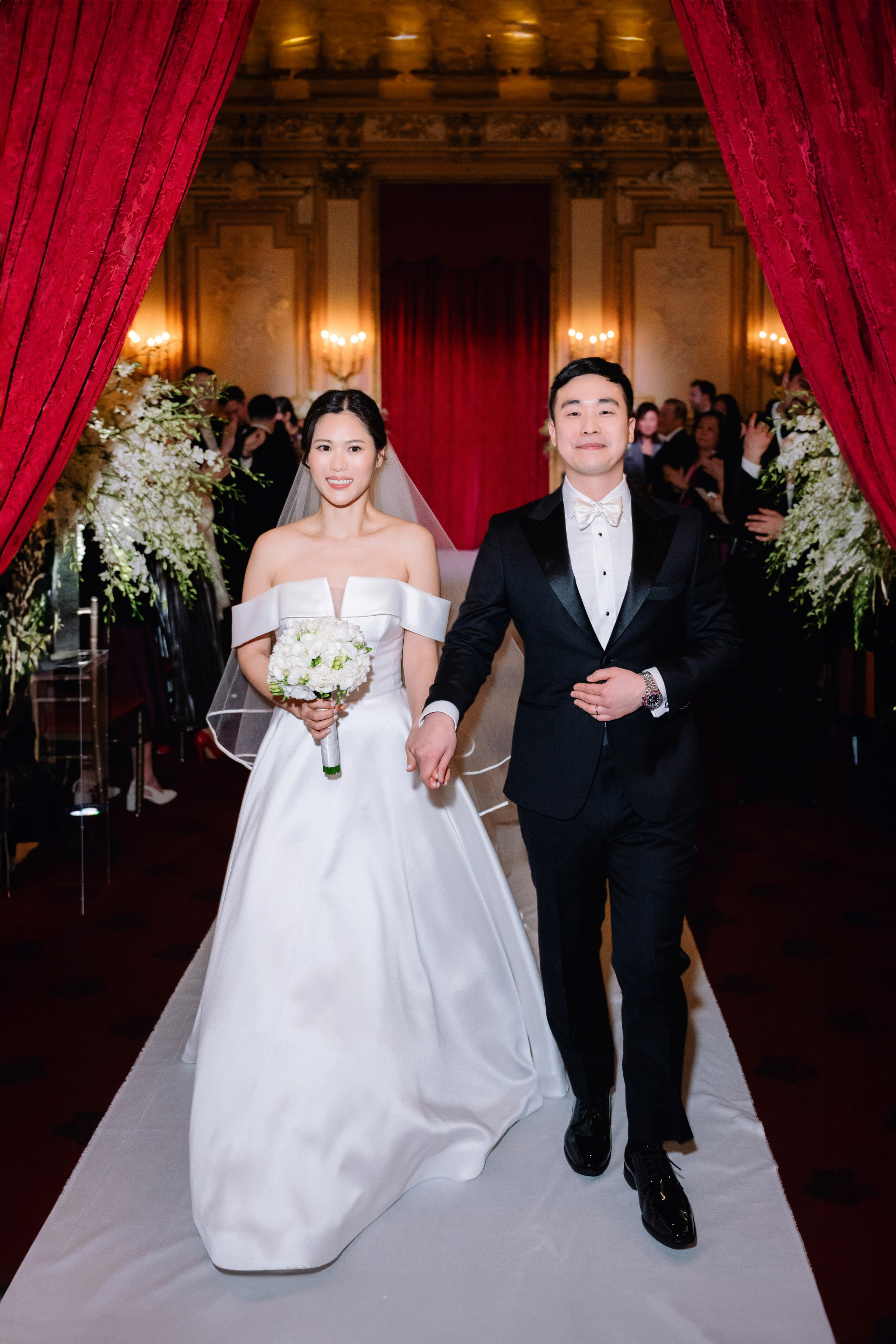 a bride and groom walking down the aisle