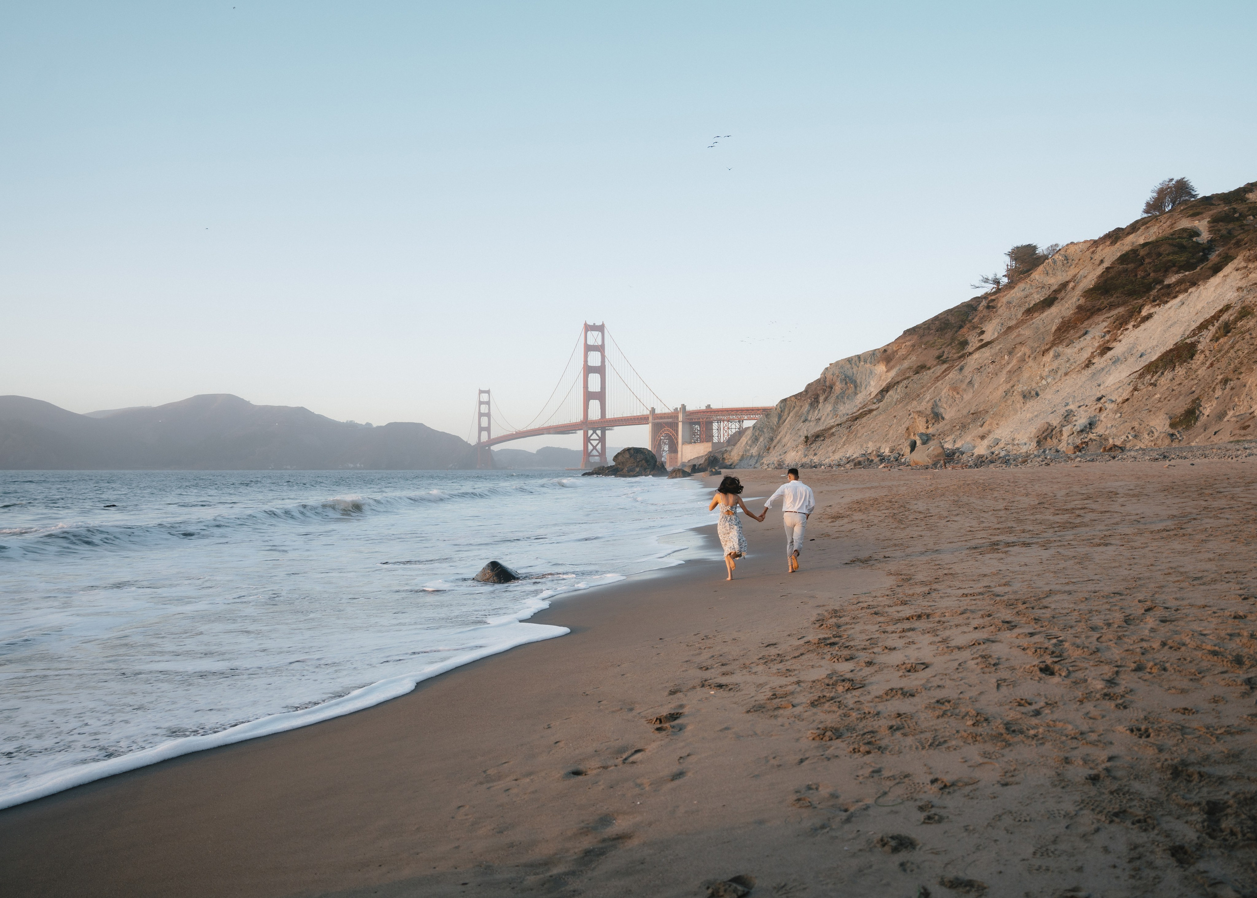 Engagement and Couple’s Photoshoot at Marshall’s Beach with iconic Golden Gate bridge view. Soulo Photography | San Francisco Bay Area Based Photographer
