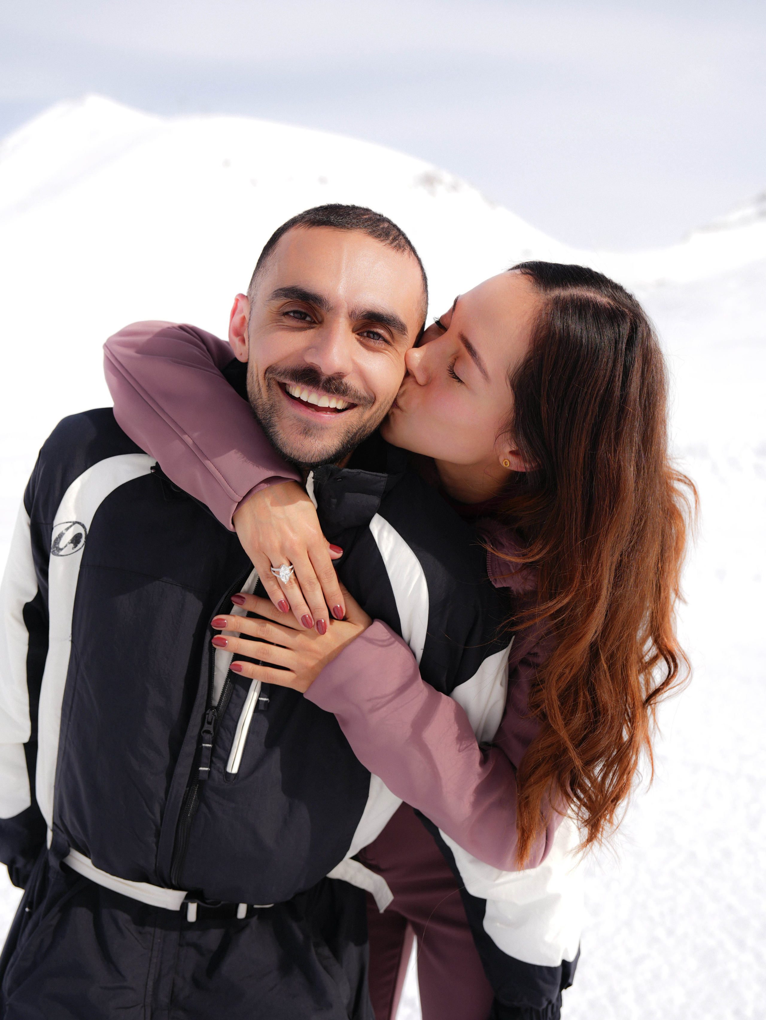 Woman kissing man after engagement moment in Gudauri Ski Resort