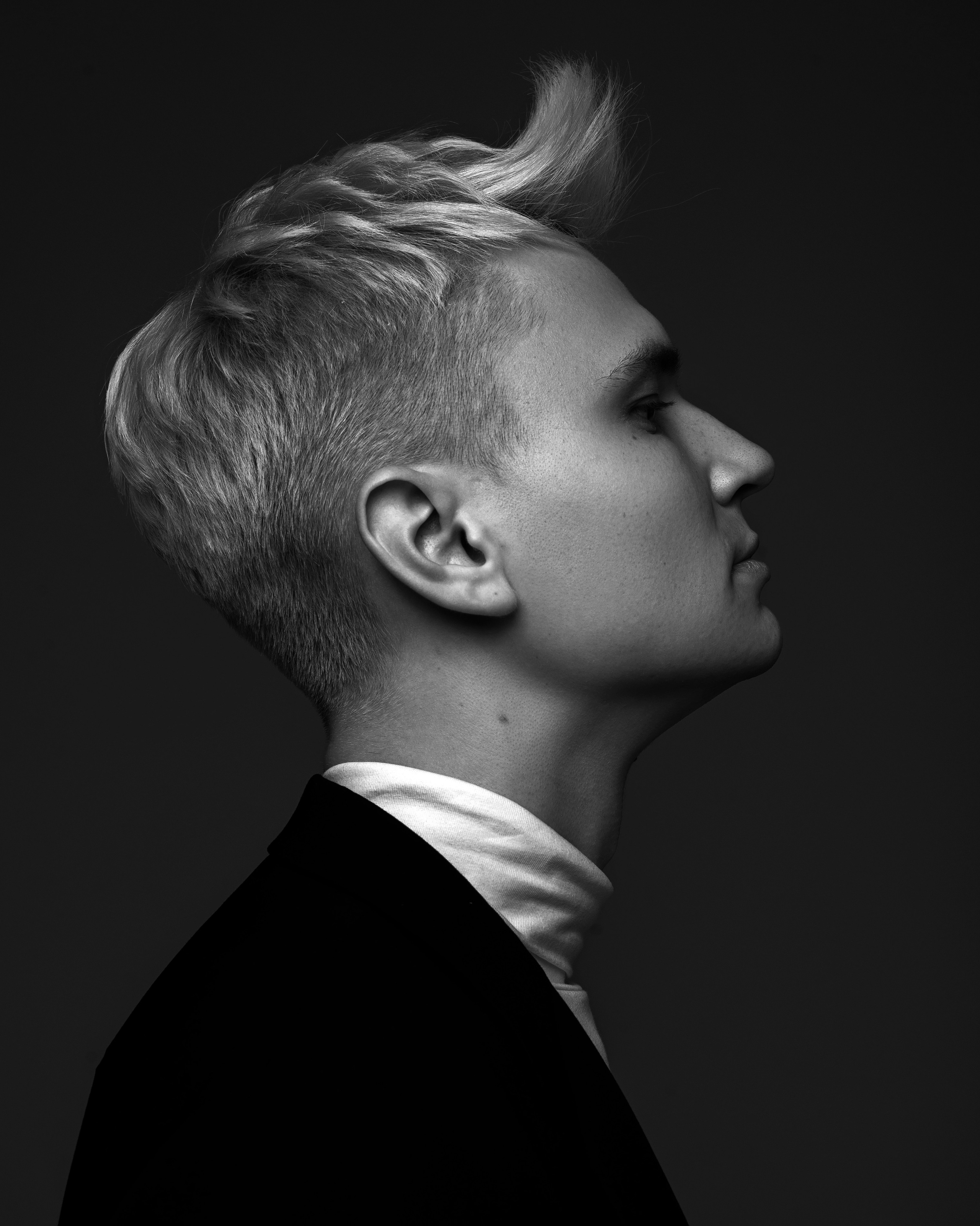 Male model portrait with dramatic hard light, editorial style fashion shoot in the studio in San Francisco.