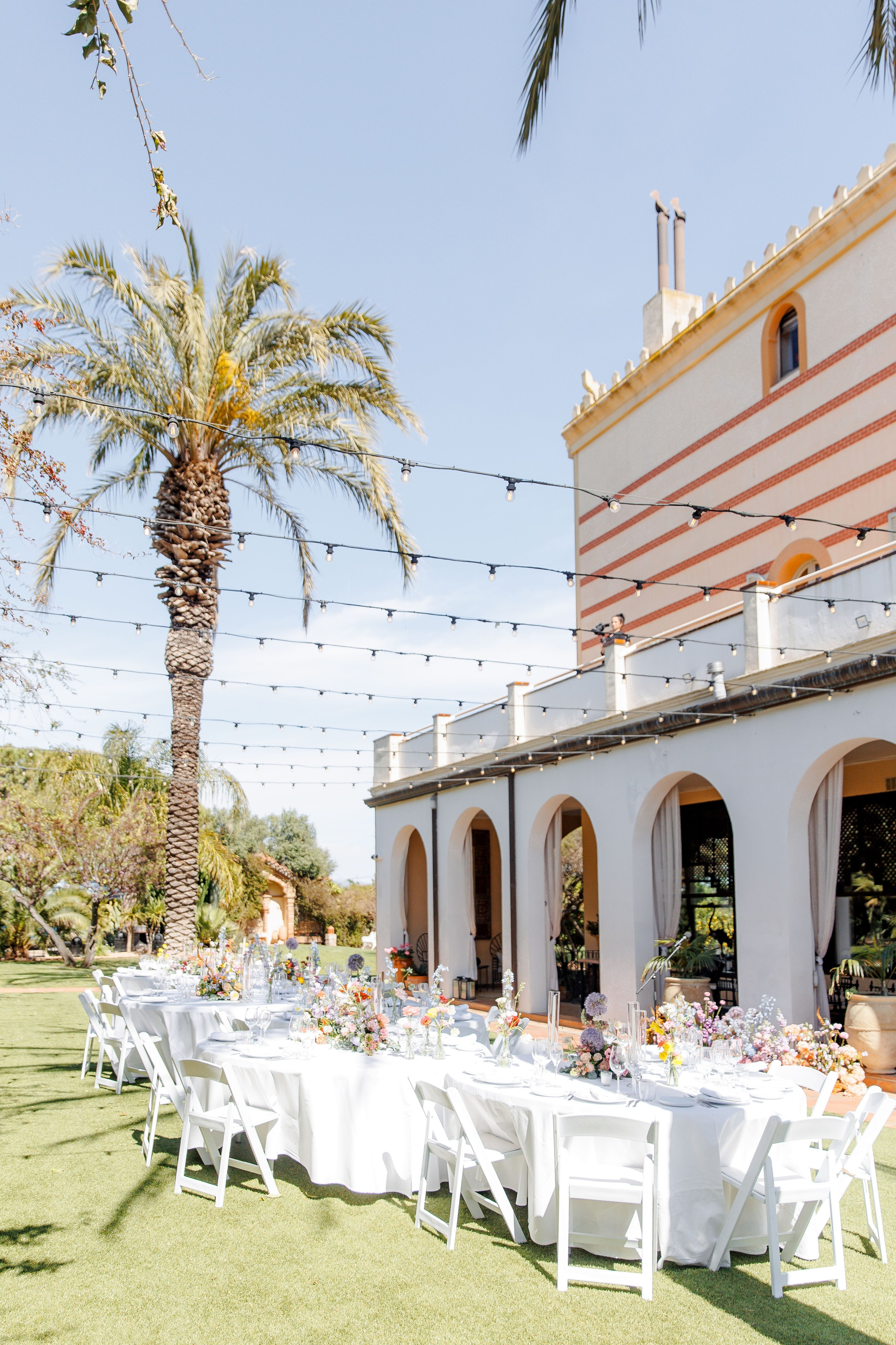 Guests are enjoying the wedding dinner at the amazing wedding venue in Spain.