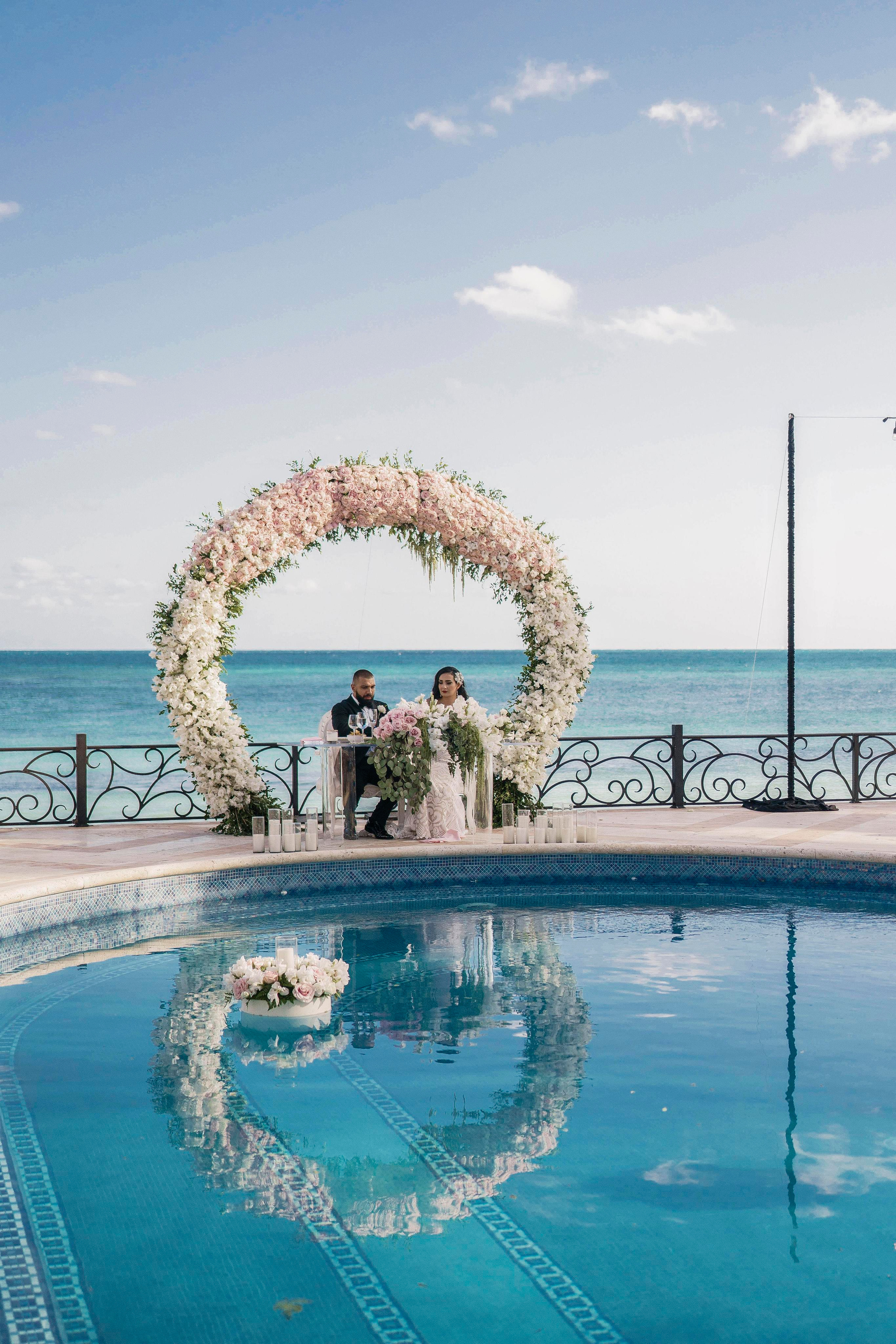 Floral ceremony arch and couple captured by fine art photographer