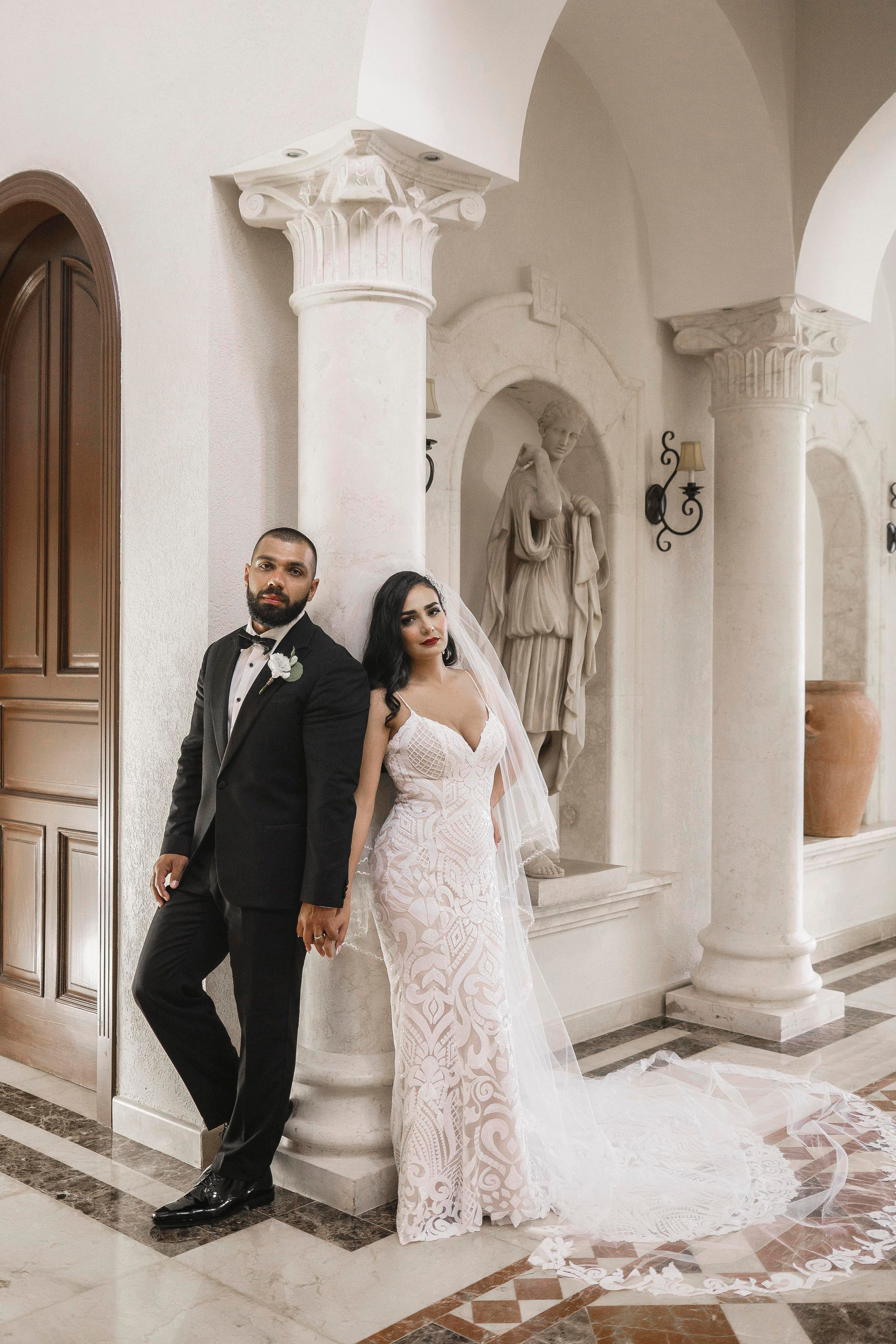 Bride and groom standing in grand hallway of Riviera Maya hacienda