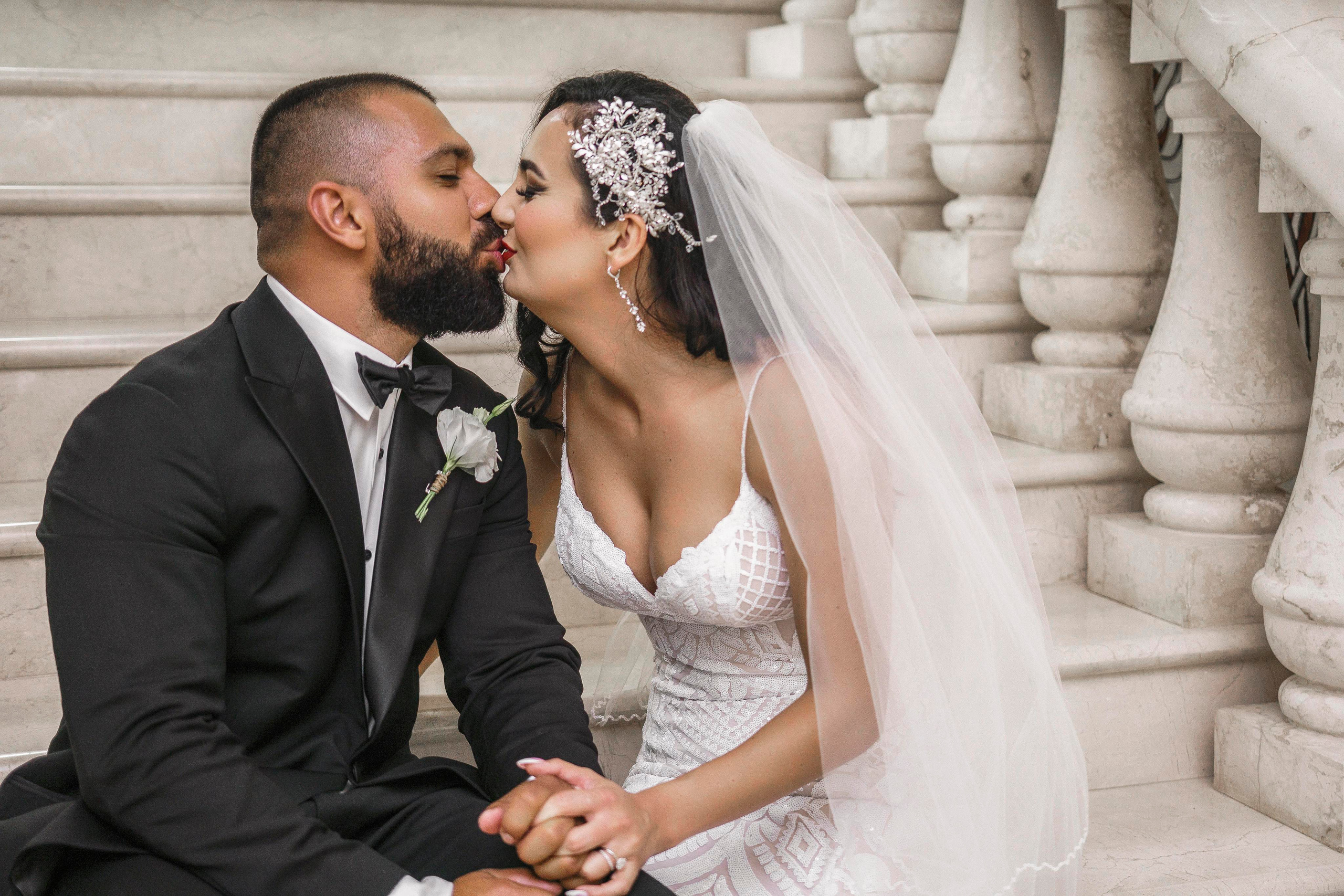 Couple holding hands inside romantic Playa del Carmen hacienda