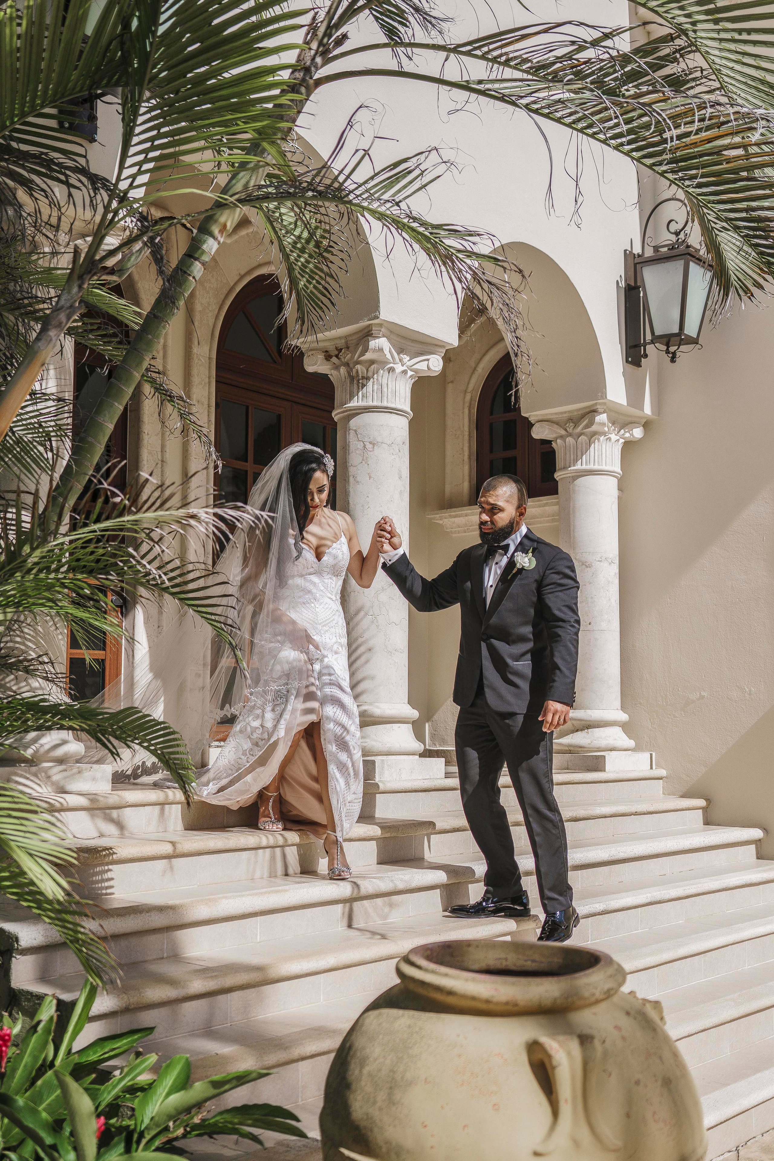 Destination wedding photo in palm-framed courtyard of Playa del Carmen hacienda