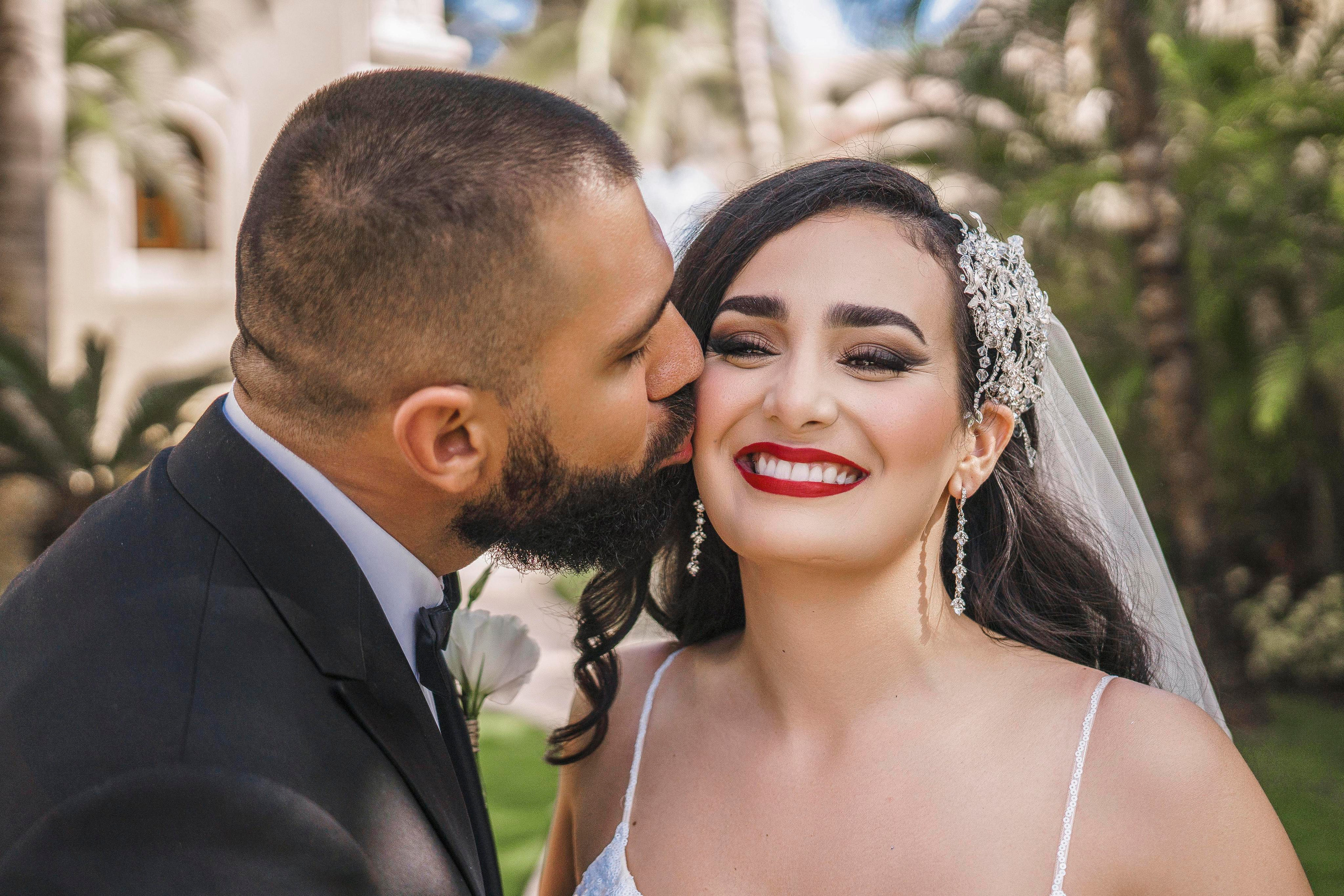 Bride’s veil flying in the breeze outside wedding venue in Mexico