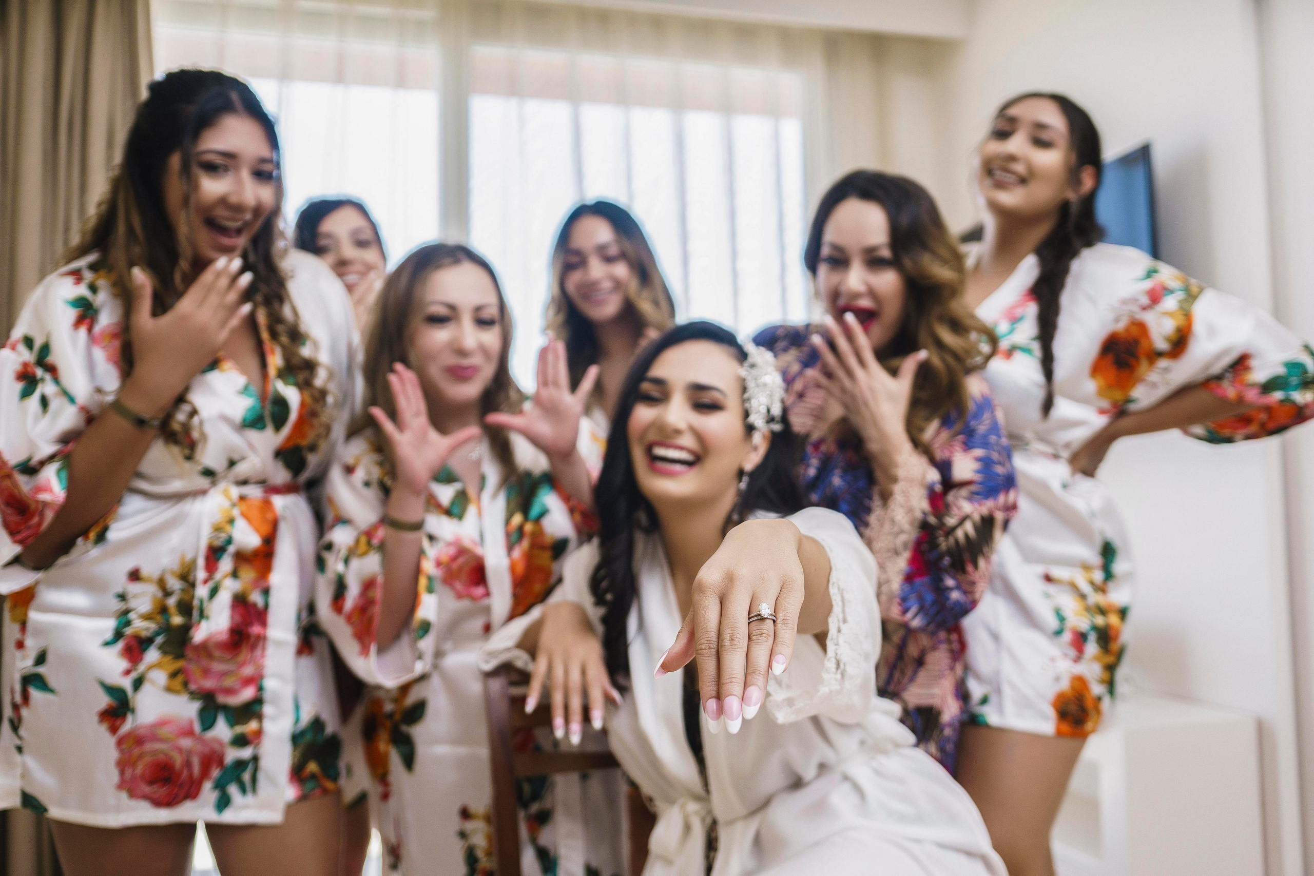 Bride and bridesmaids laughing in getting ready photo – Cancun wedding photographer