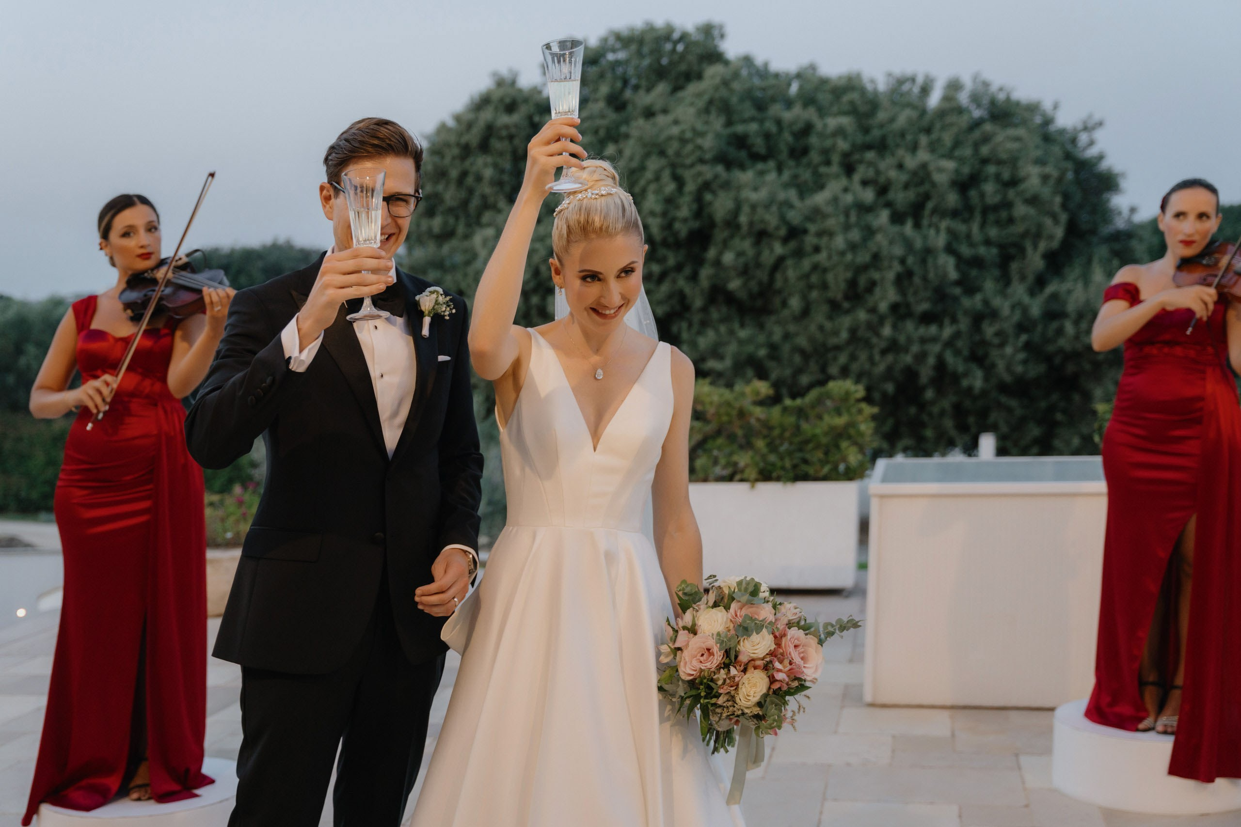 Bride and groom during evening reception with warm lighting, cinematic destination wedding in Ostuni Italy