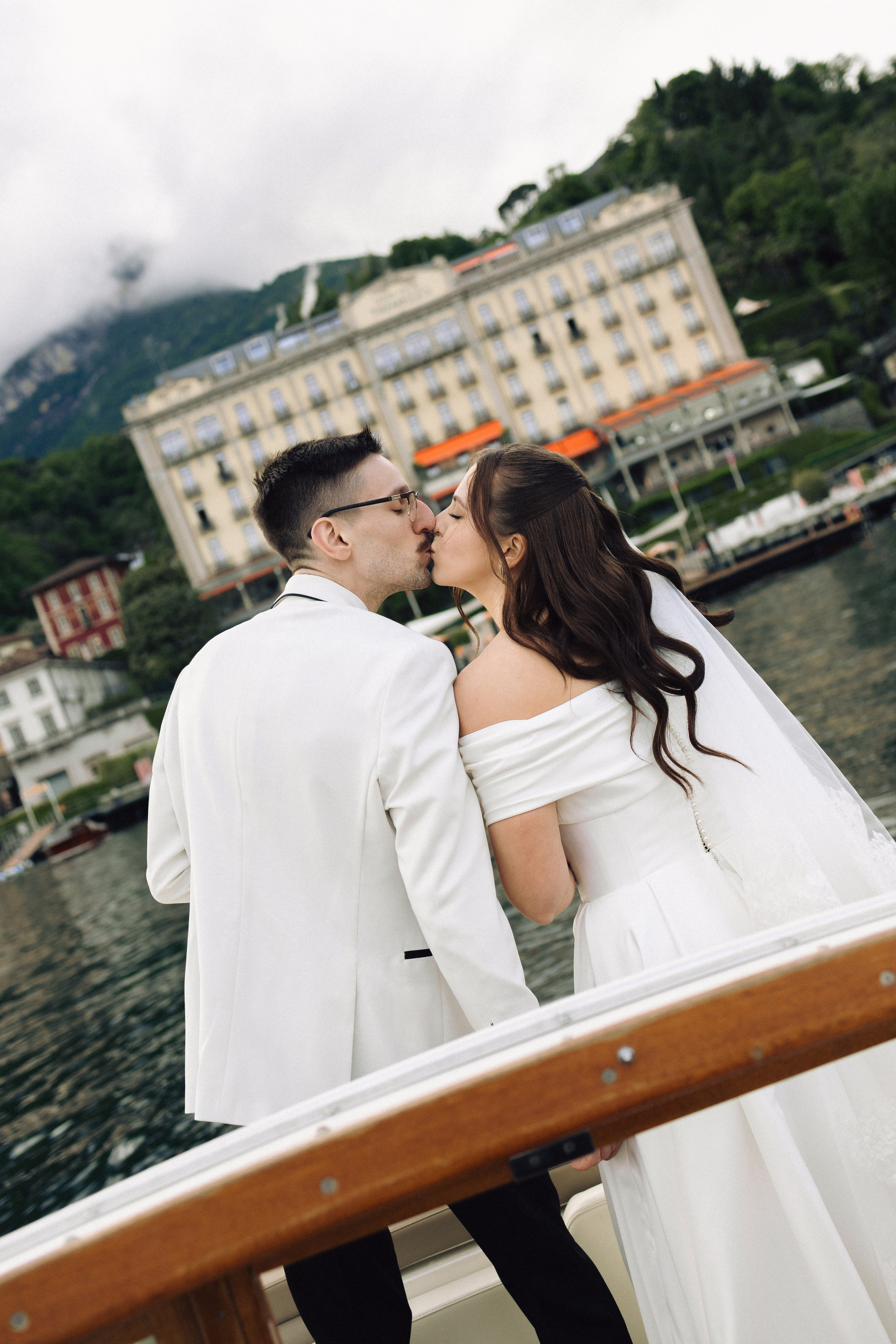 Newlyweds sharing a quiet moment by the water in Bellagio