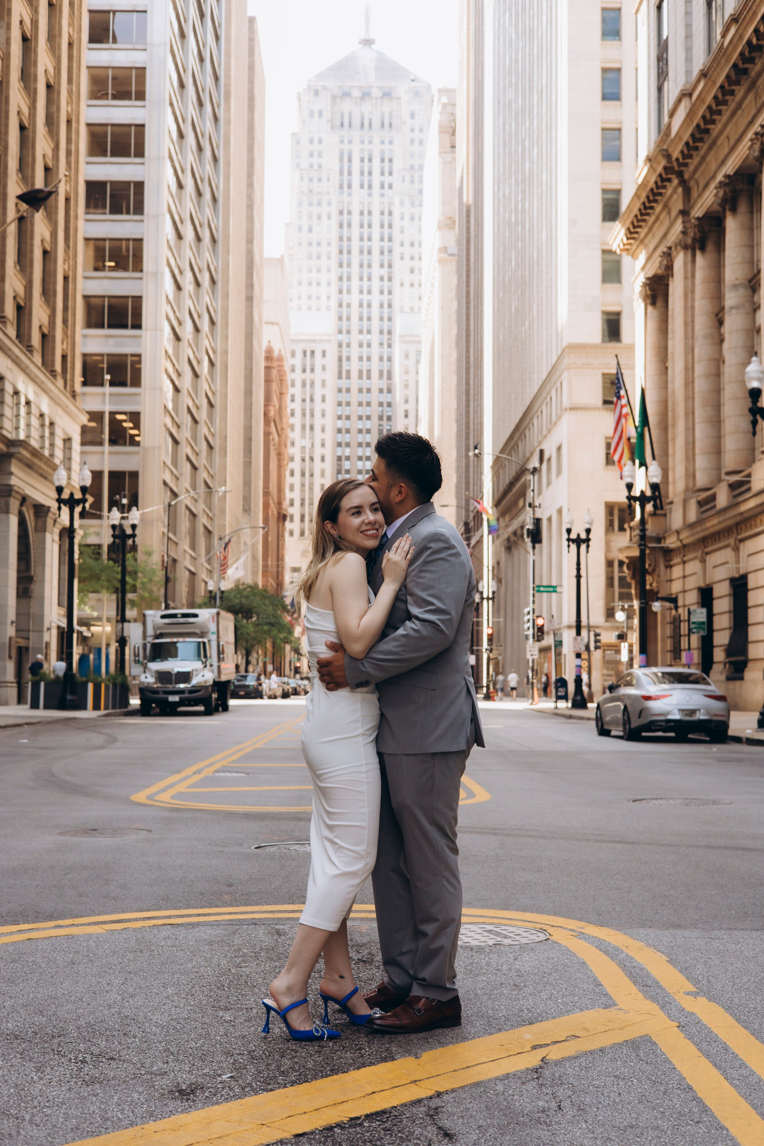 Bride and groom hugging with downtown Chicago skyscrapers behind them