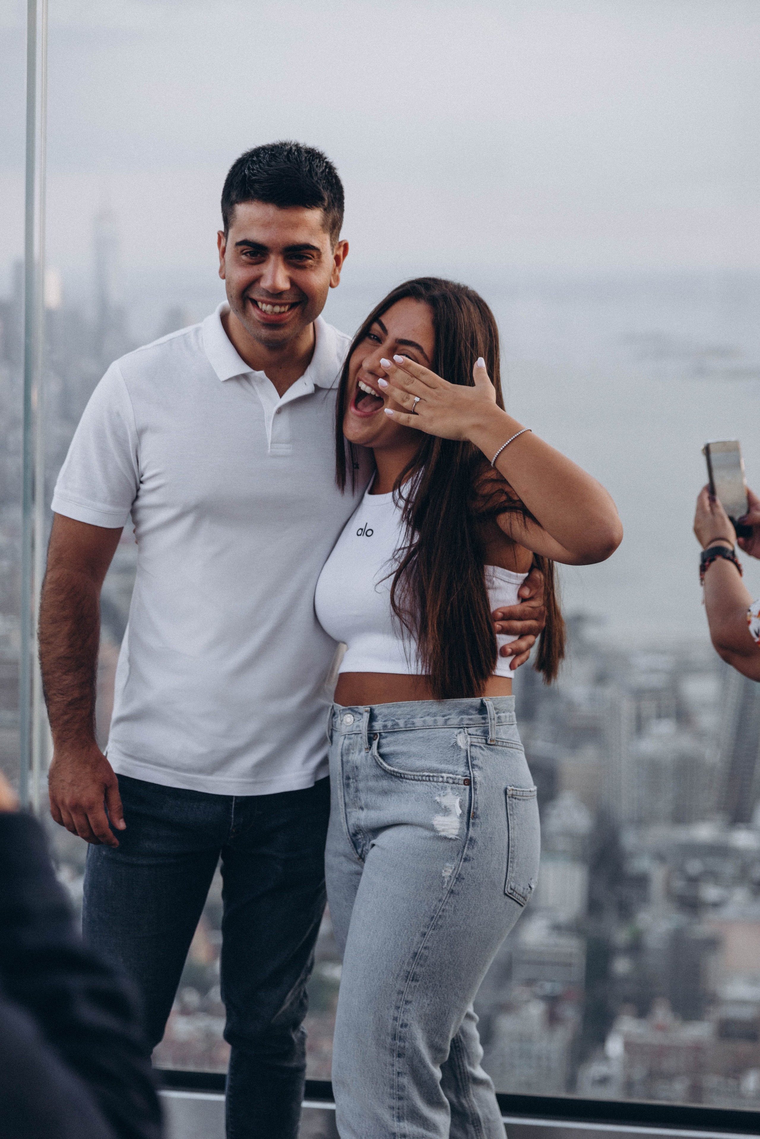 Couple hugging after proposal in Times Square.