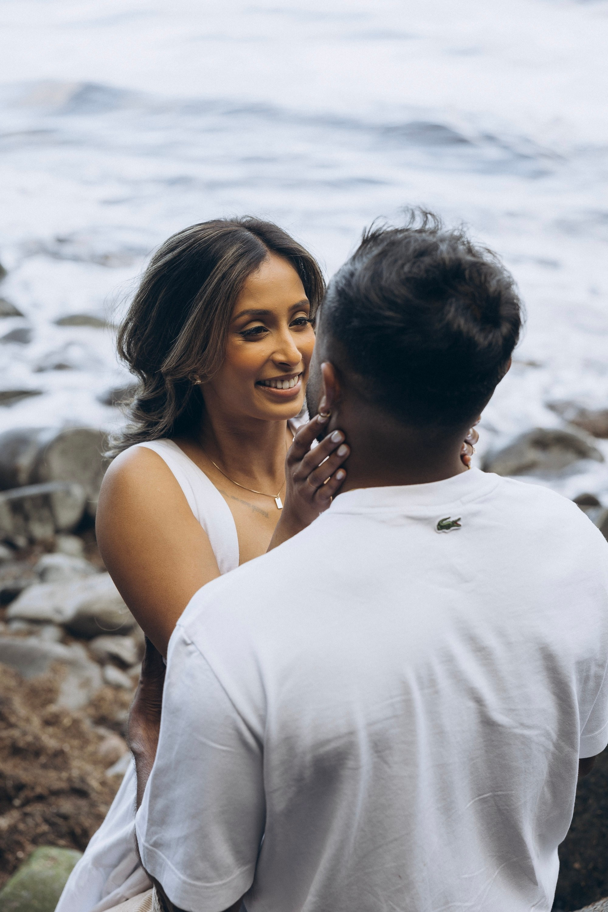 Romantic proposal on Seixal Beach, Madeira — black sand and ocean waves.