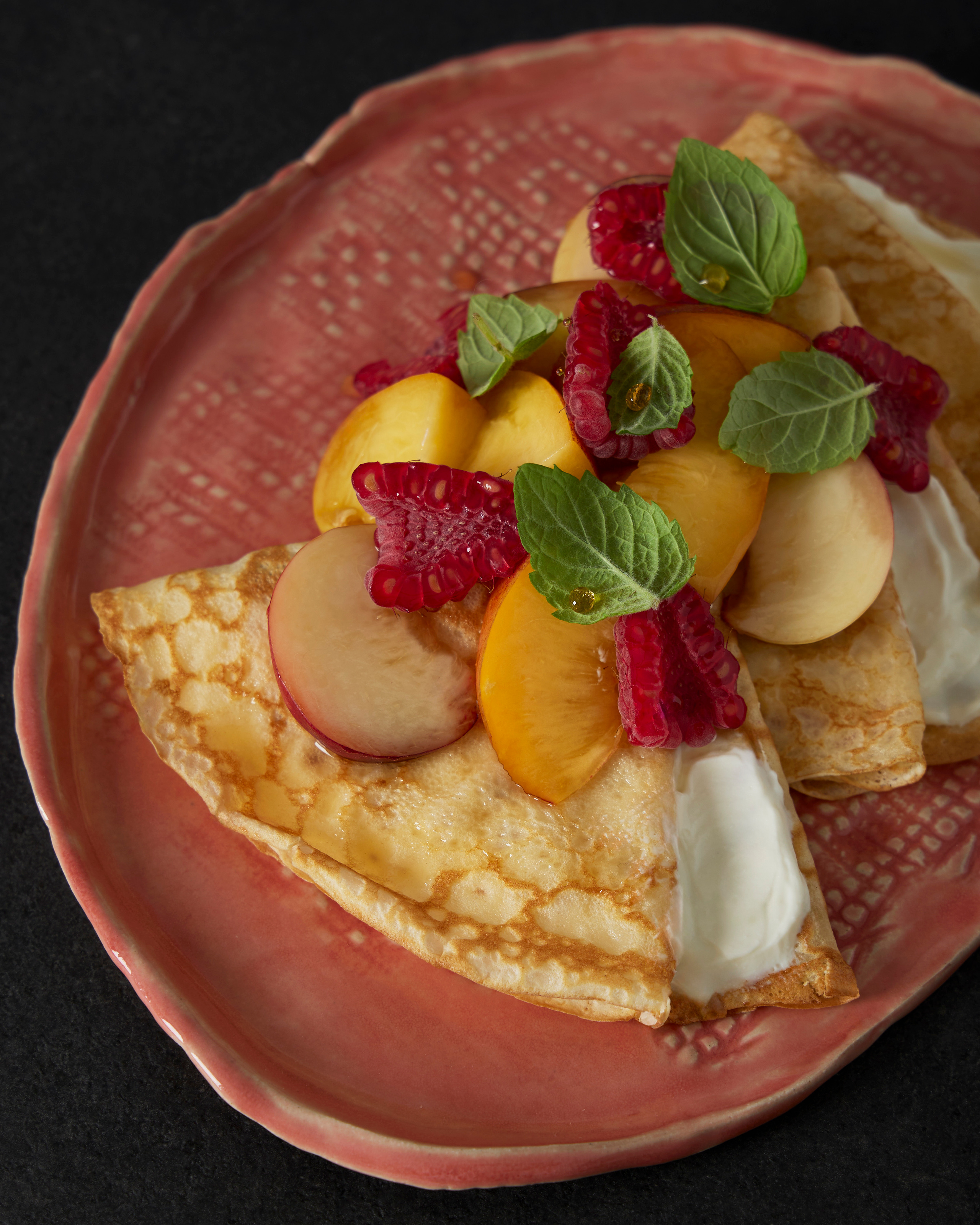crepes with whipped ricotta, fresh berries and fruits, beautiful plate