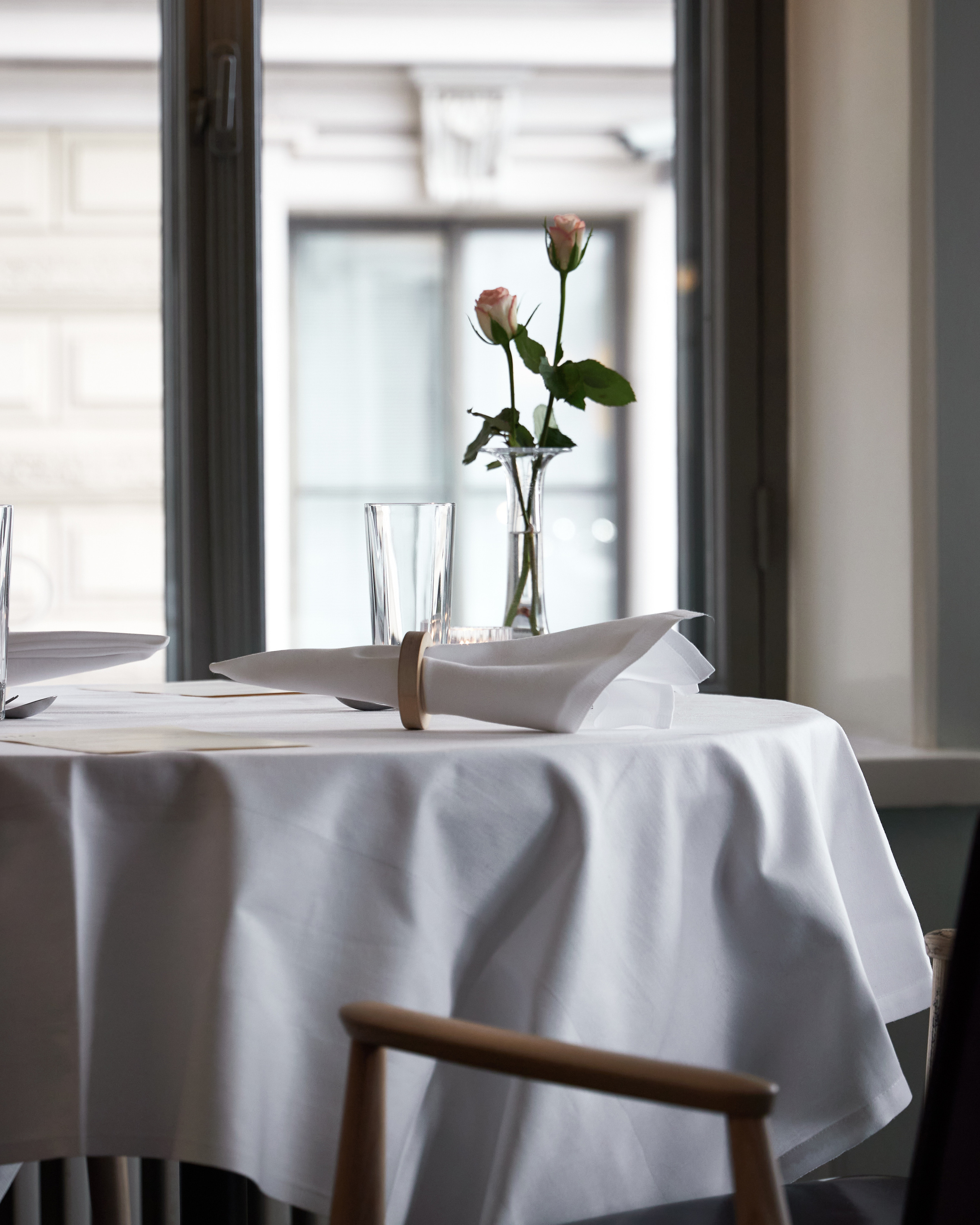 white table, two roses in a vase, olo