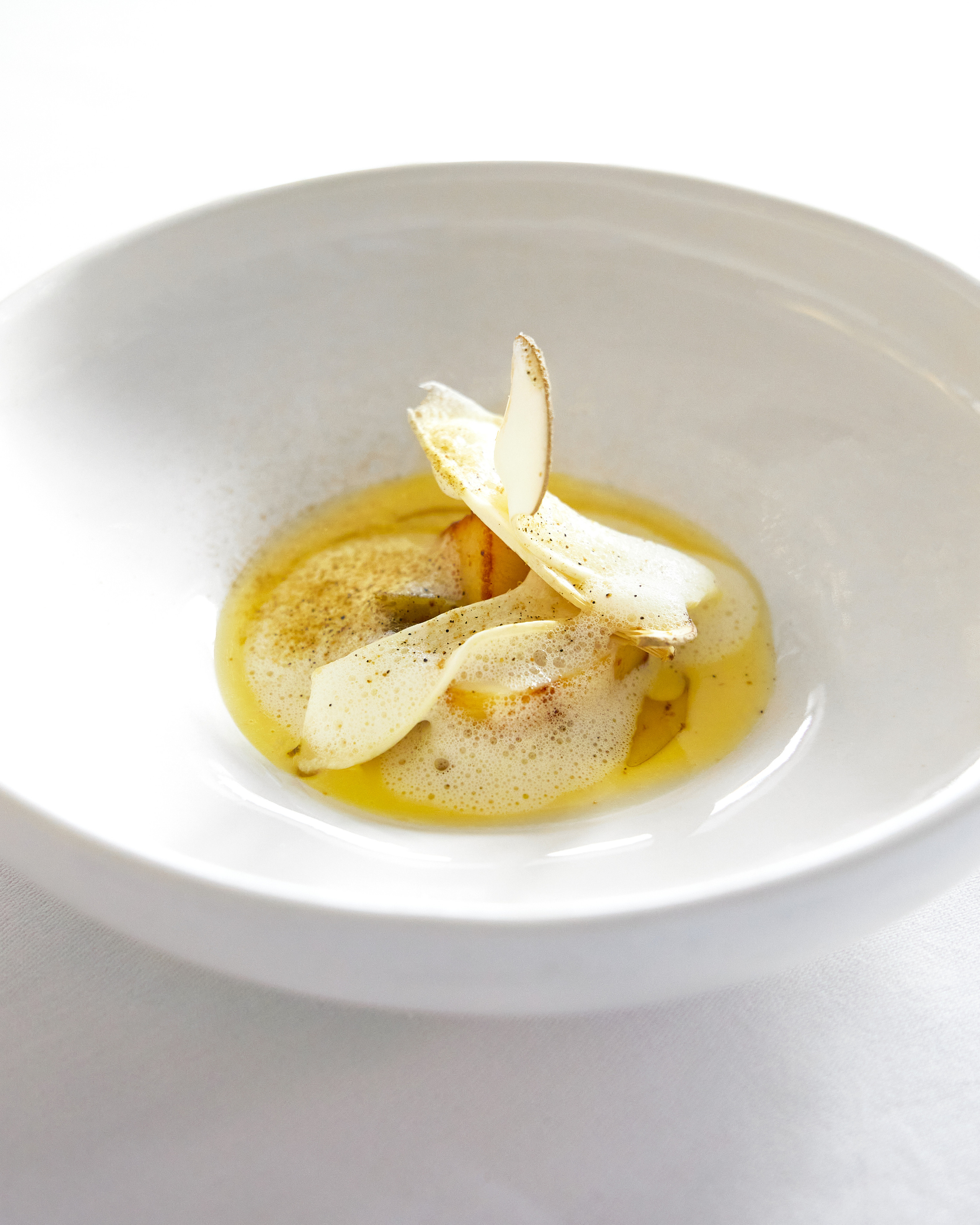 slightly cooked scallop with mussel broth and sunflower seed