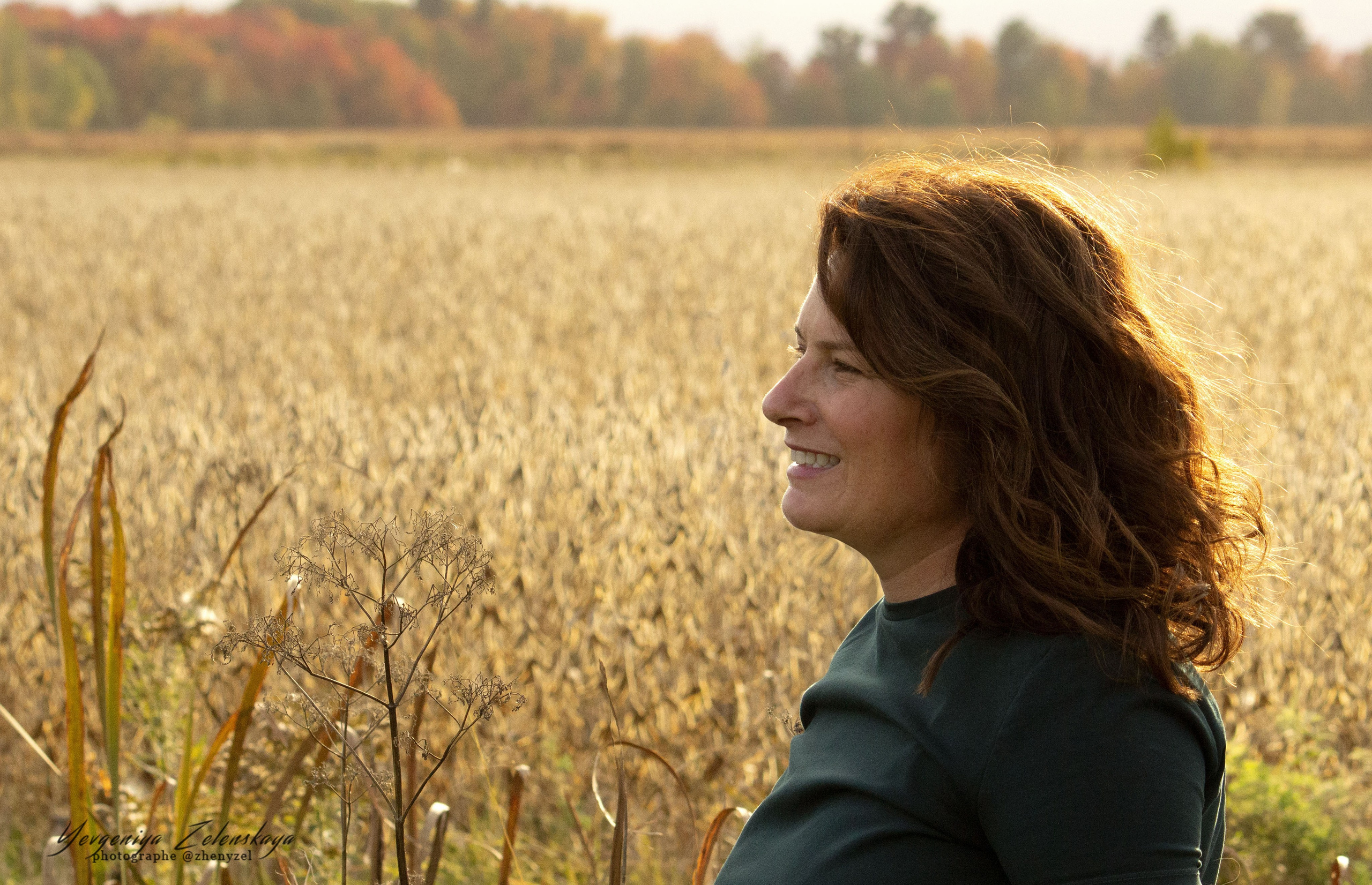 Woman enjoying golden autumn light during a fall portrait session in Calgary