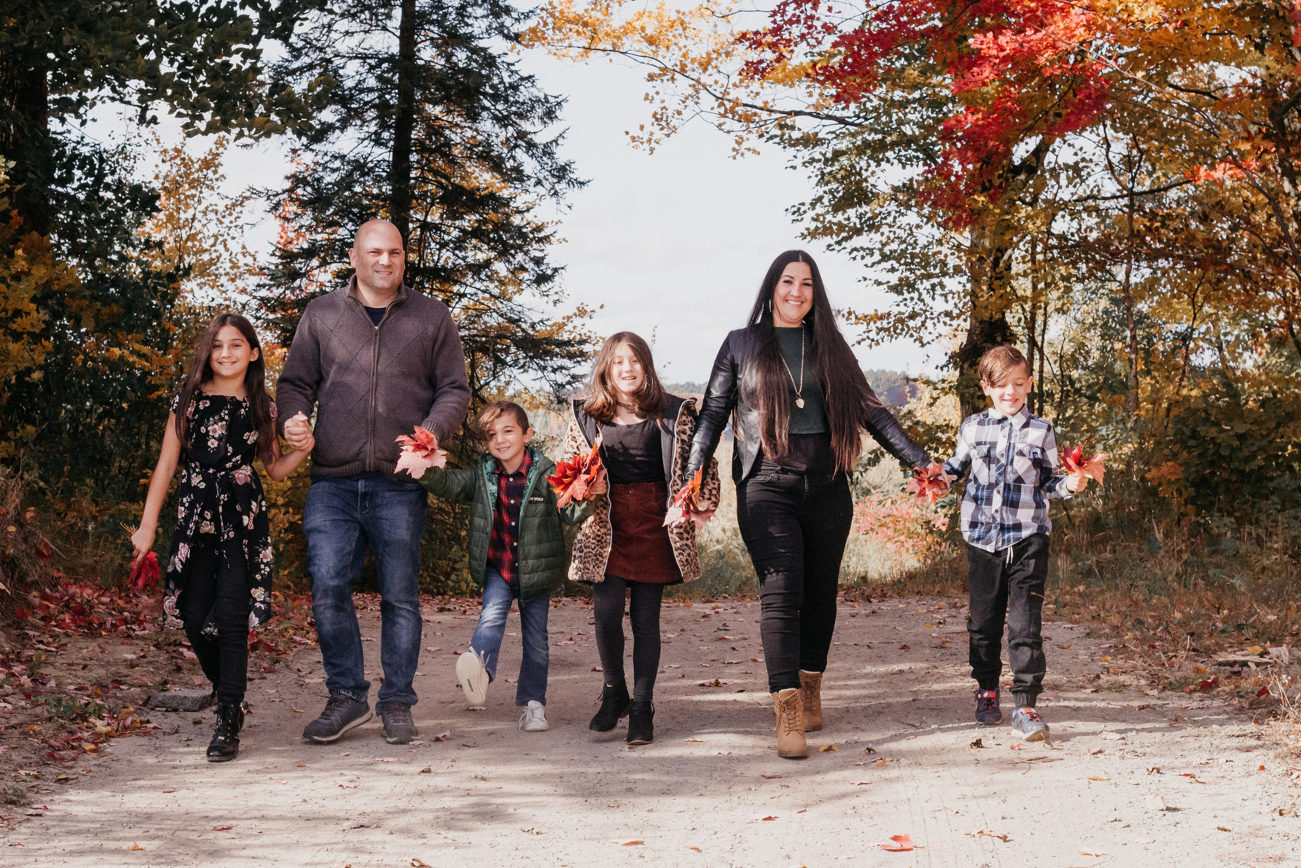 Family walking together during a fall photography session in Calgary