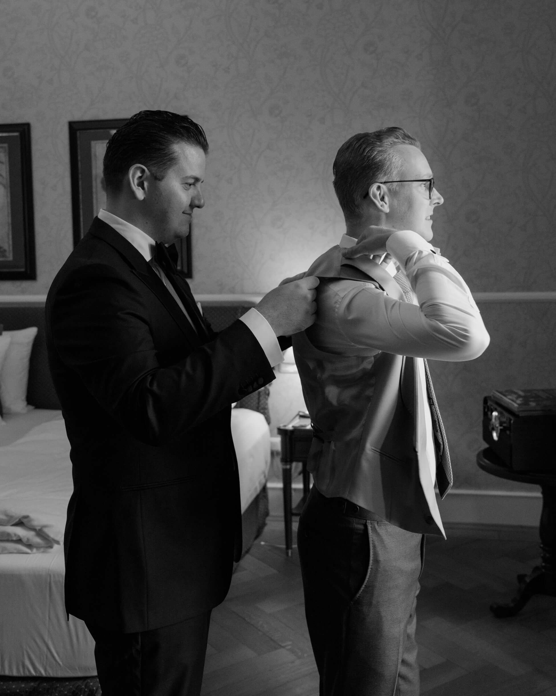 Groom and best man getting dressed together, black tie wedding Frankfurt Villa Rothschild