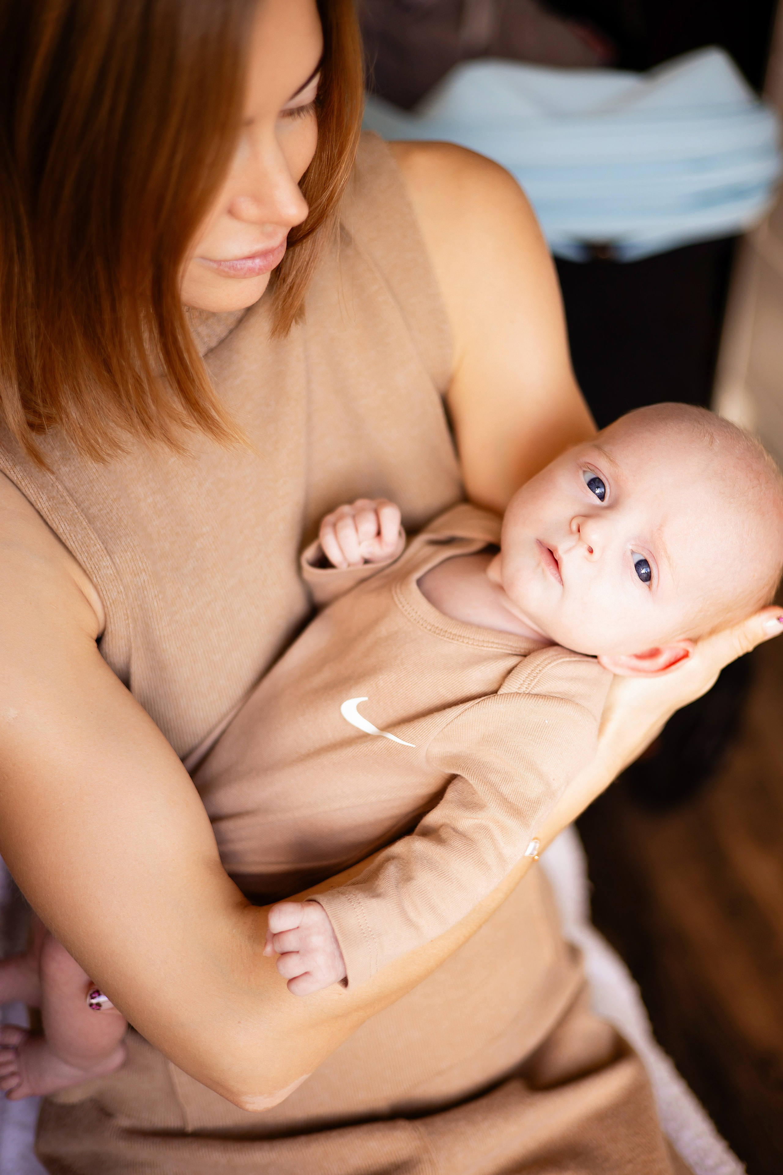 Family photoshoot with a newborn on the living room couch