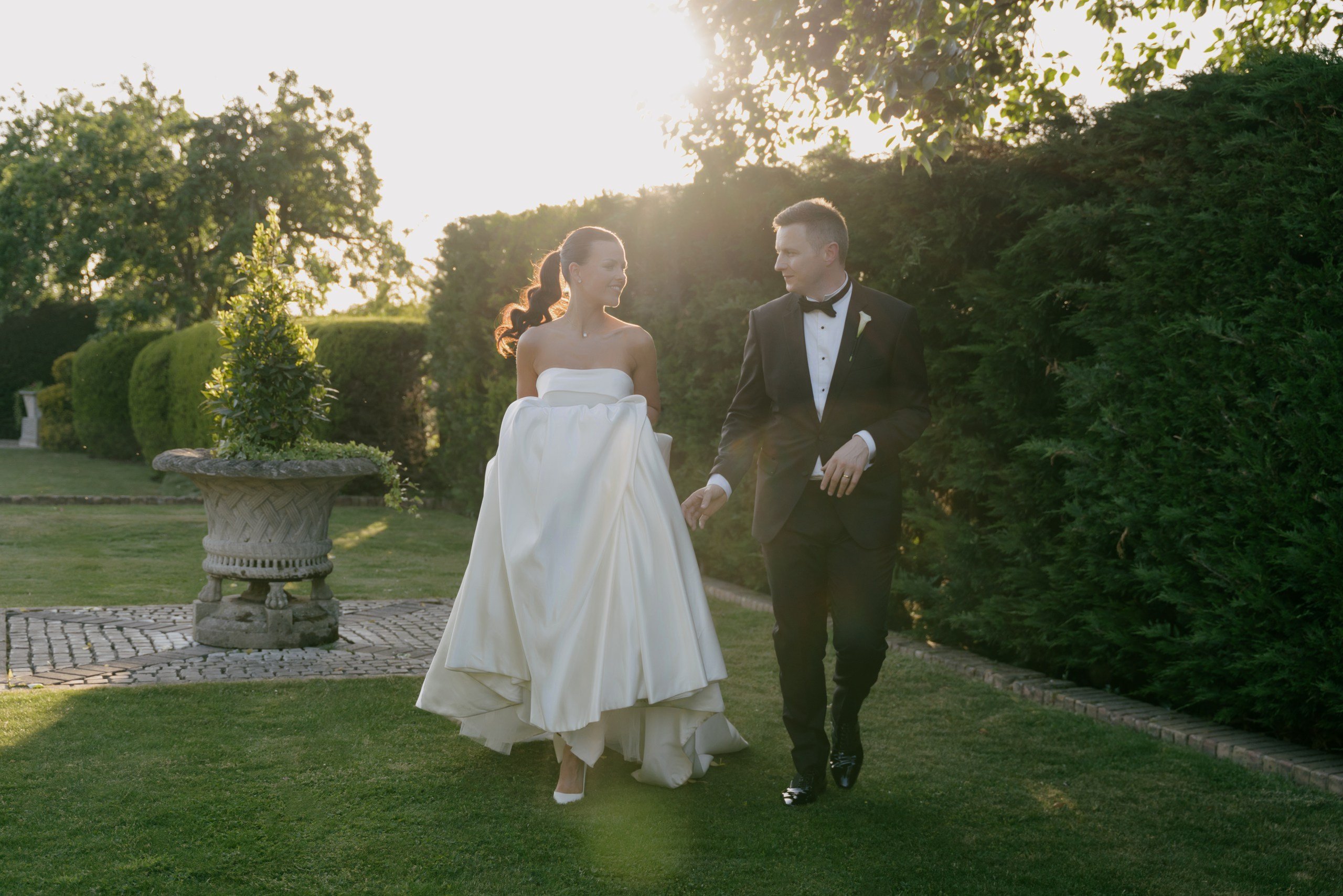 Bride and groom walking together at Friern Manor wedding venue