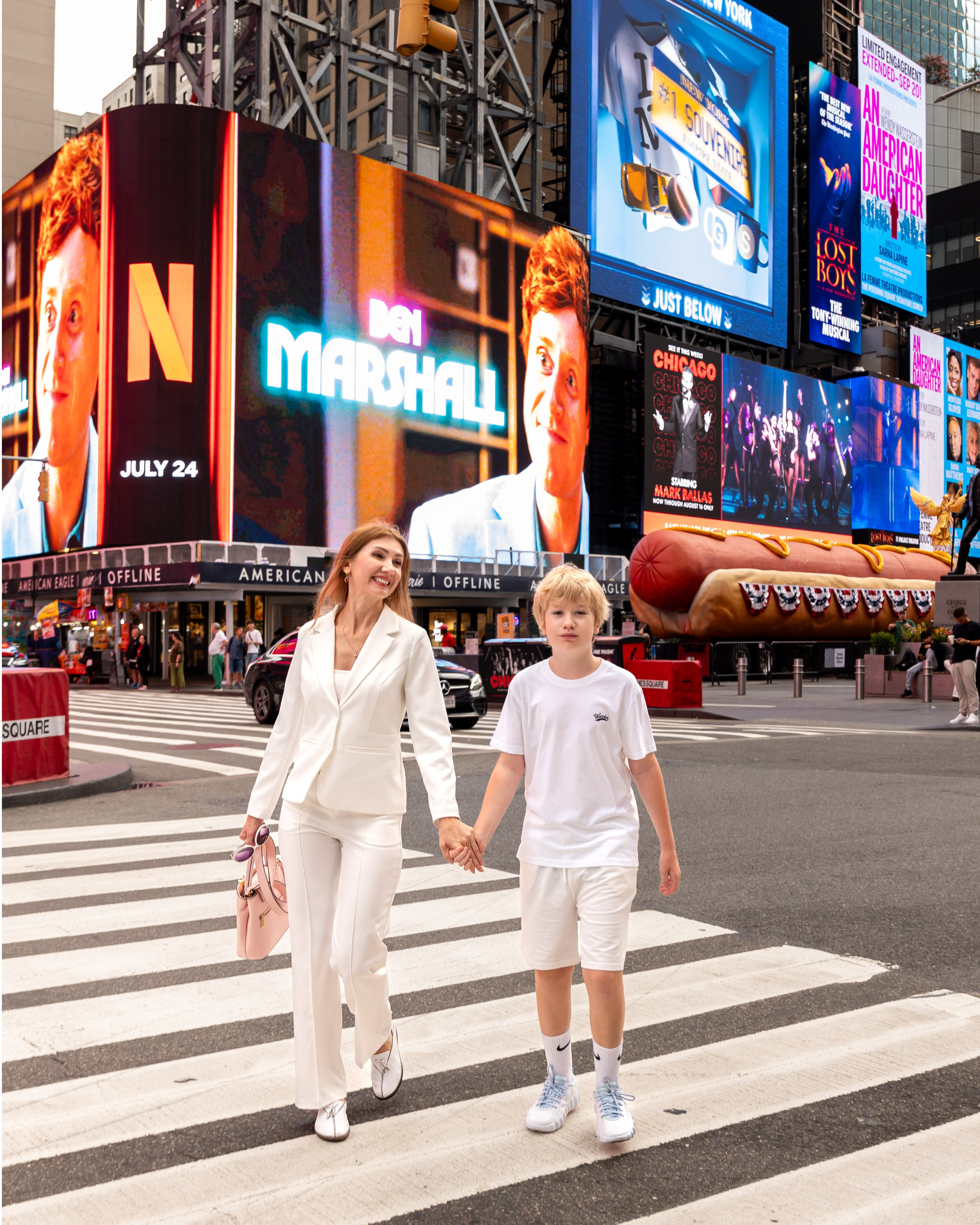 Stylish portrait with a classic convertible and famous Times Square steam
