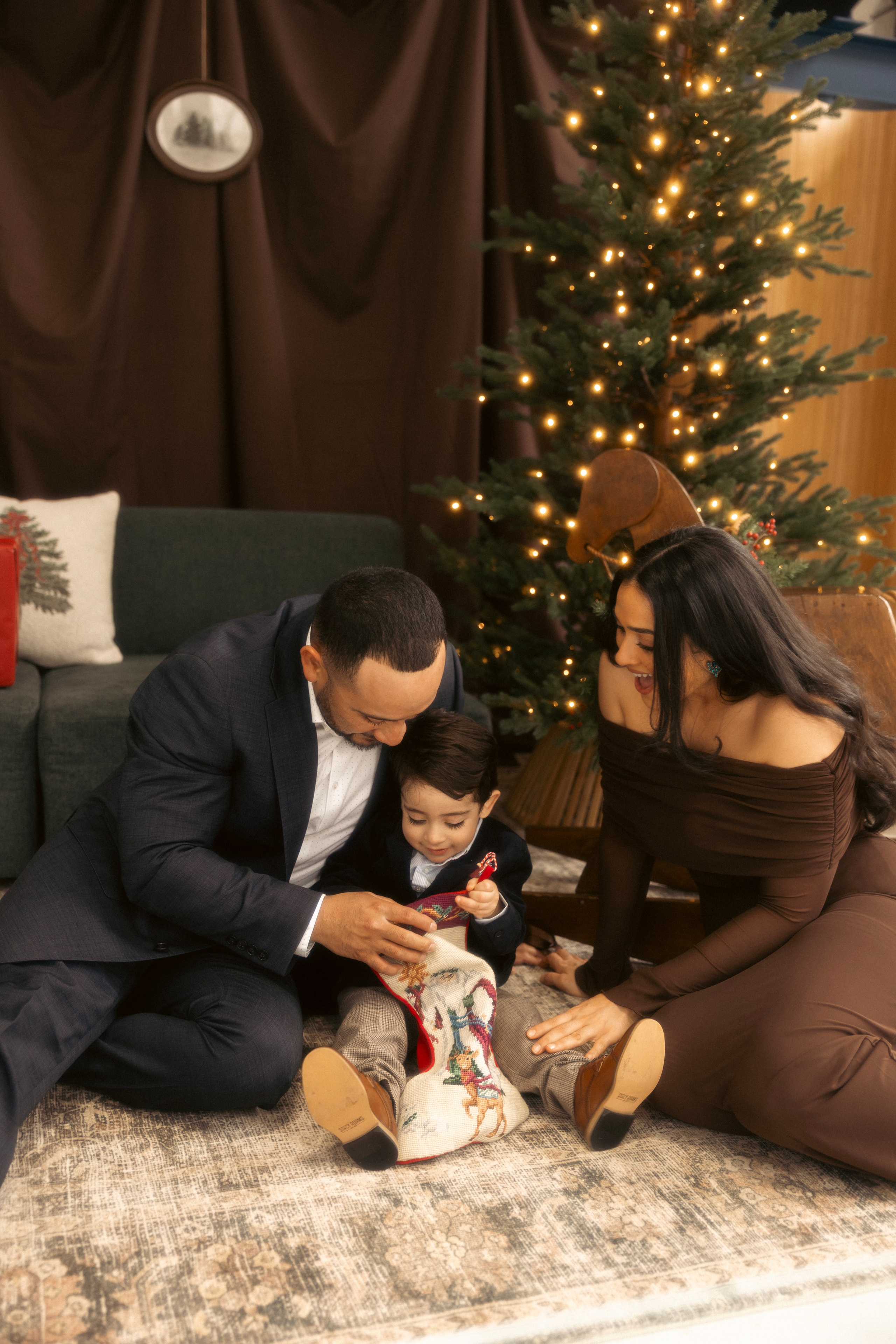 Baby smiling during Christmas mini shoot with festive lights