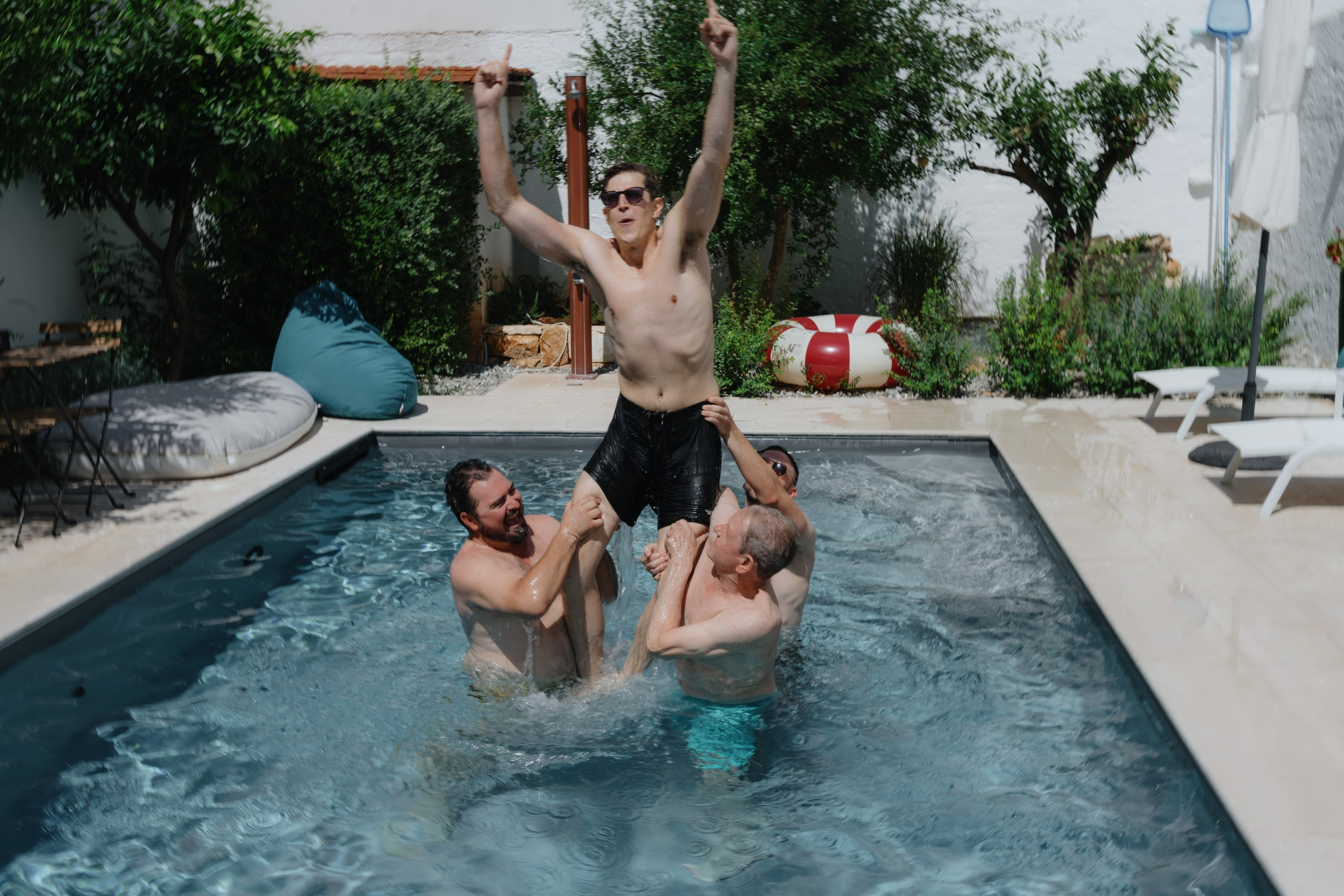 Groom having fun by the swimming pool at Masseria Traetta Ostuni wedding