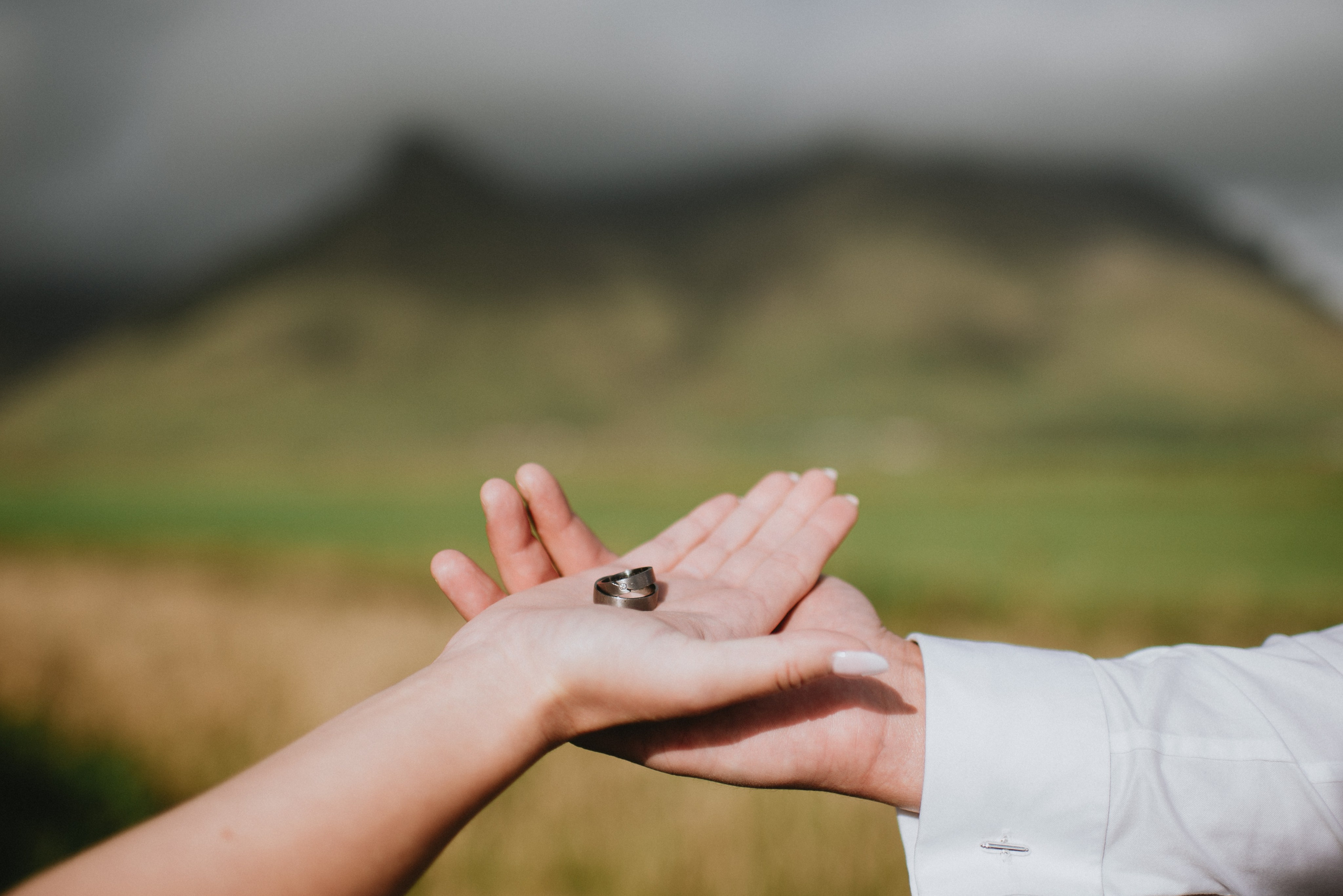 Eloping couple exploring the lush green canyon near Kvernufoss, surrounded by untouched Icelandic nature.