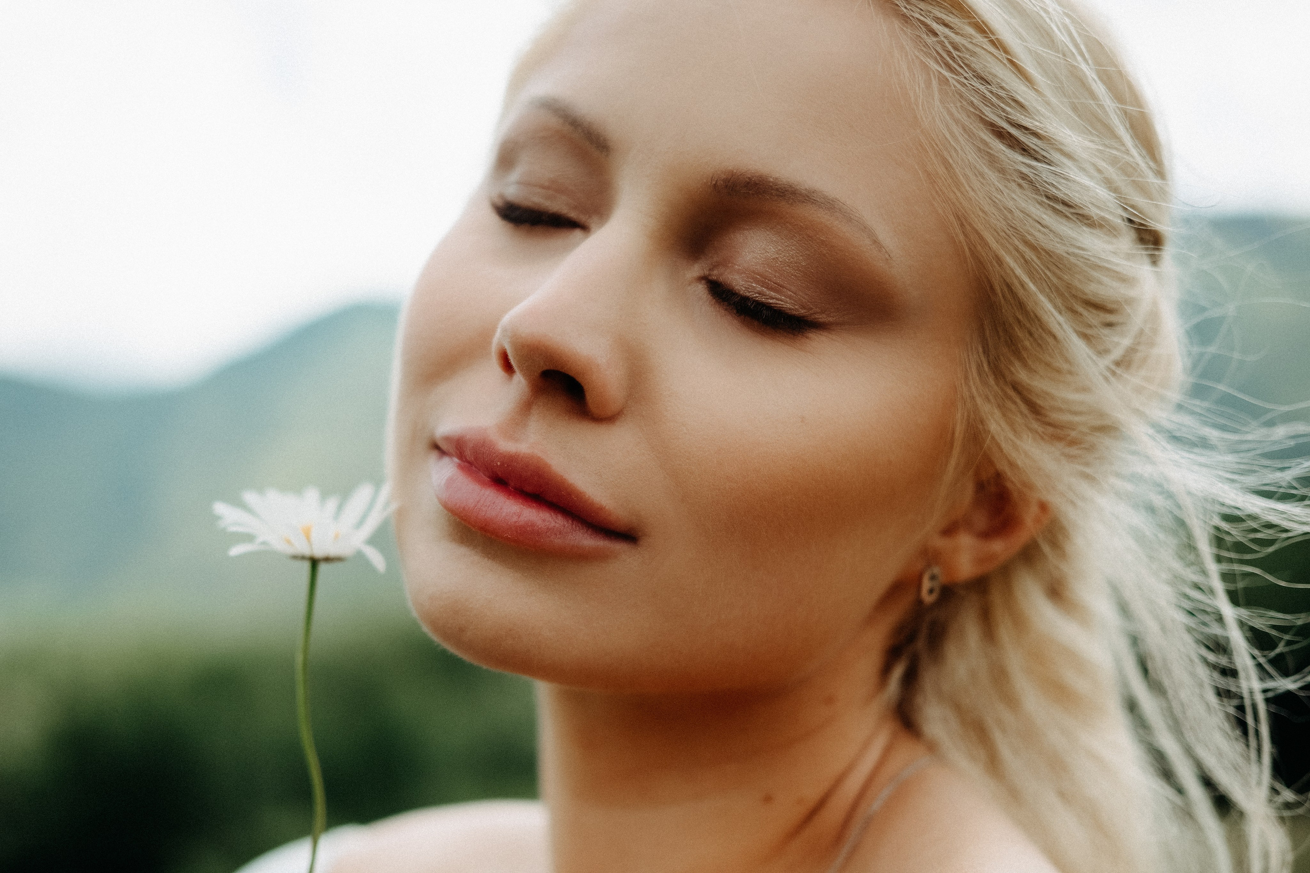 Close up portrait with flower in mountain setting