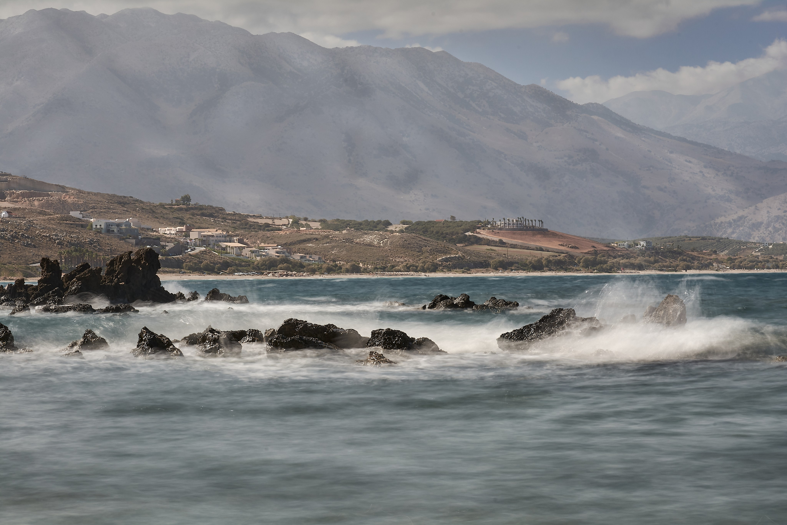 Waves crashing over rocky Mediterranean coastline