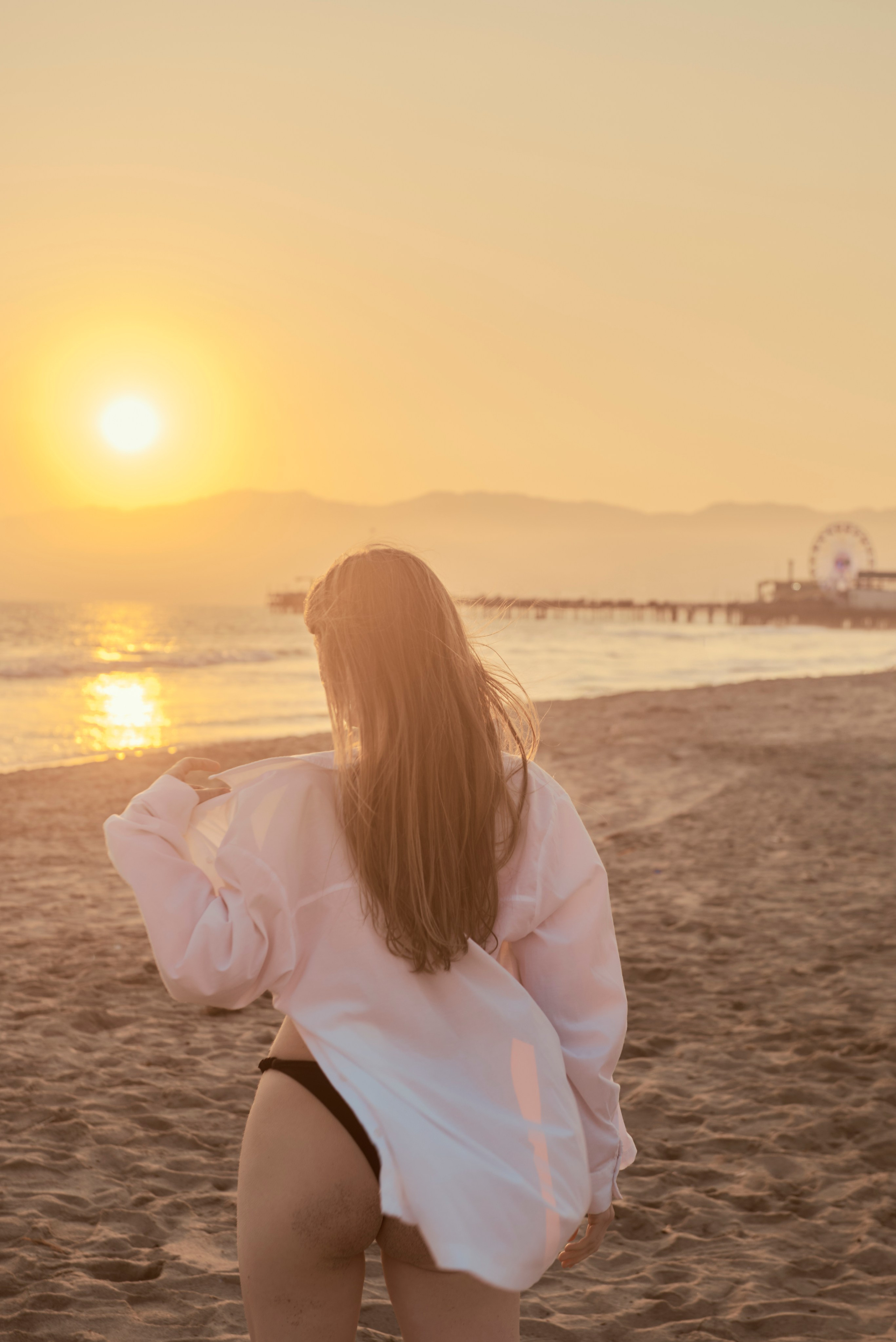 Stunning girl on the beach with soft sunset light