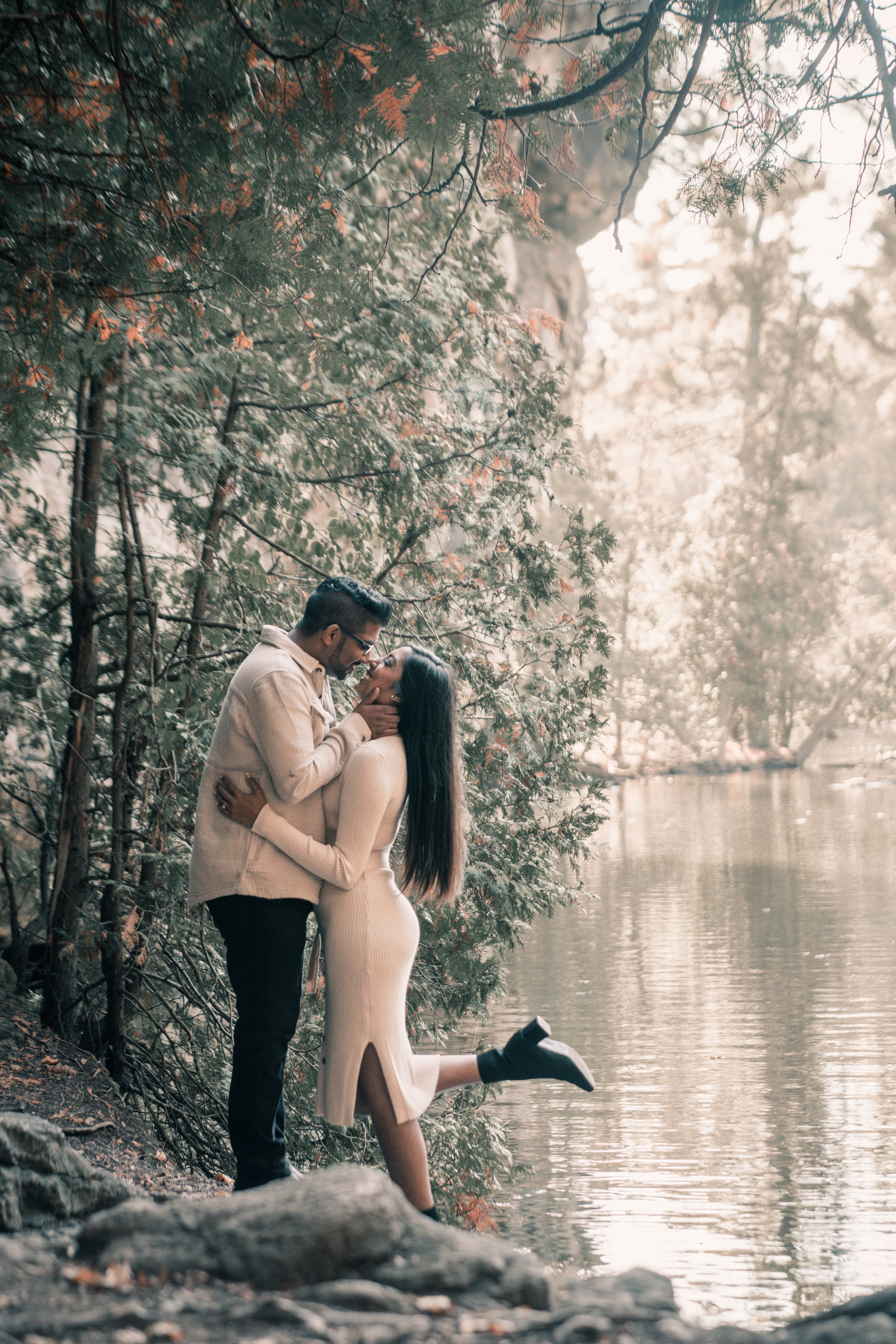 Couple walking through a golden autumn park, capturing their engagement moments