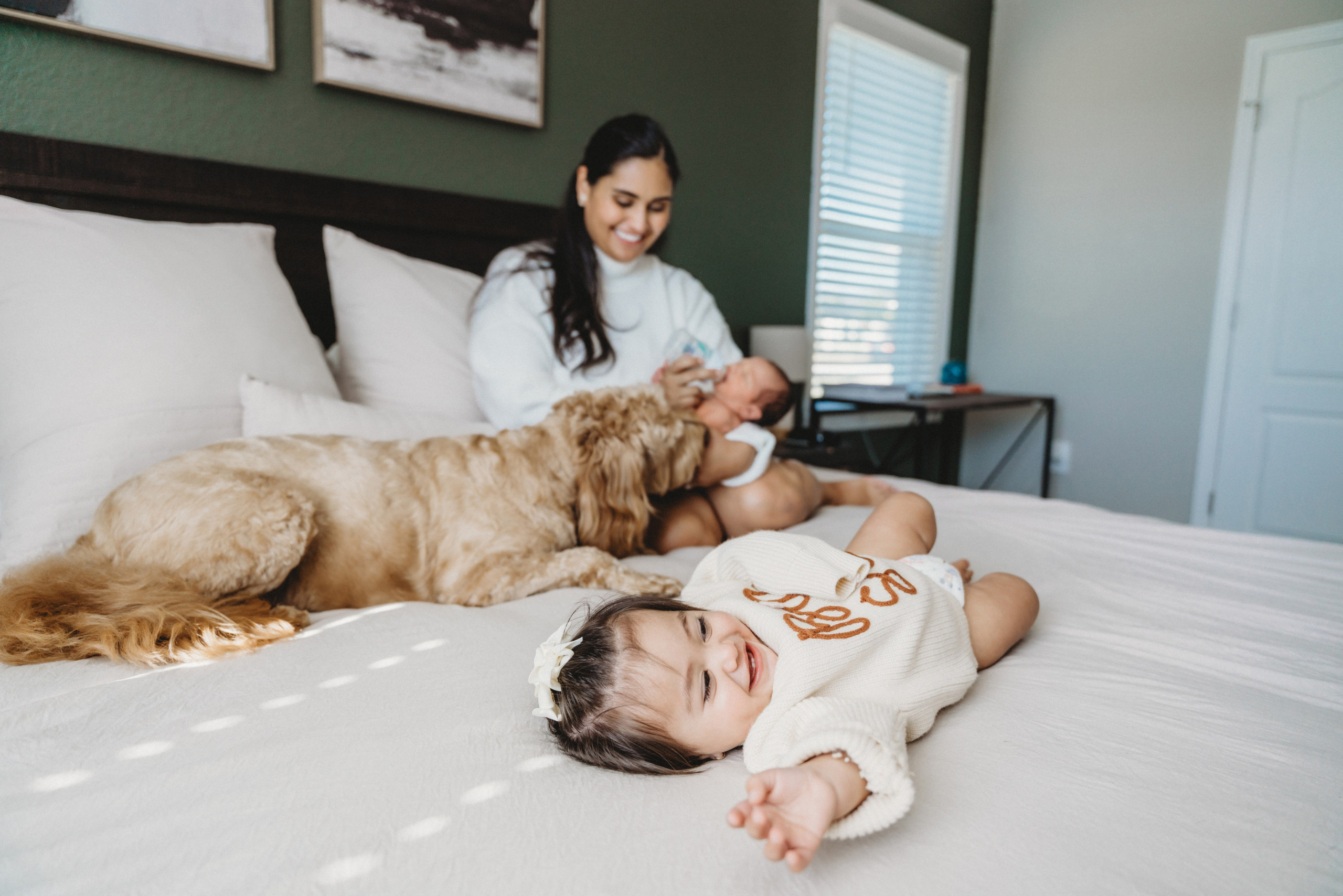 Mother with her kids on the bed