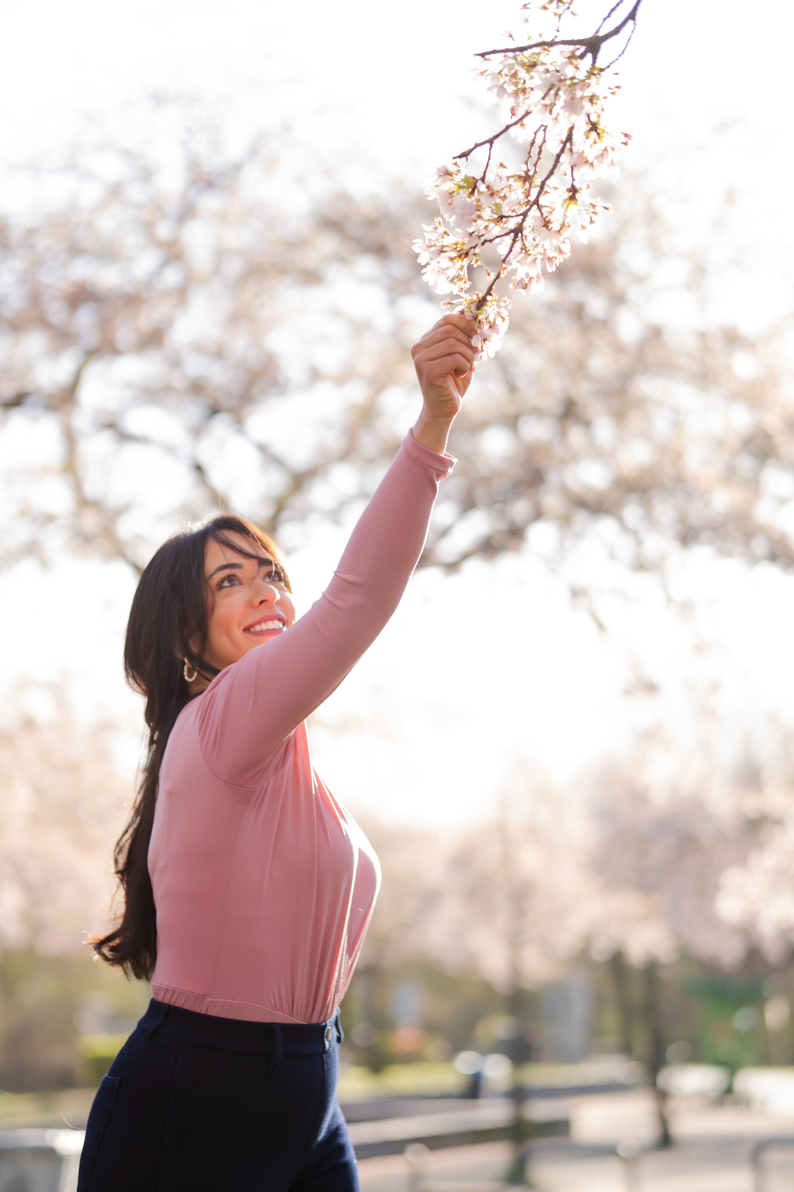 girl holding a cherry blossoms branch