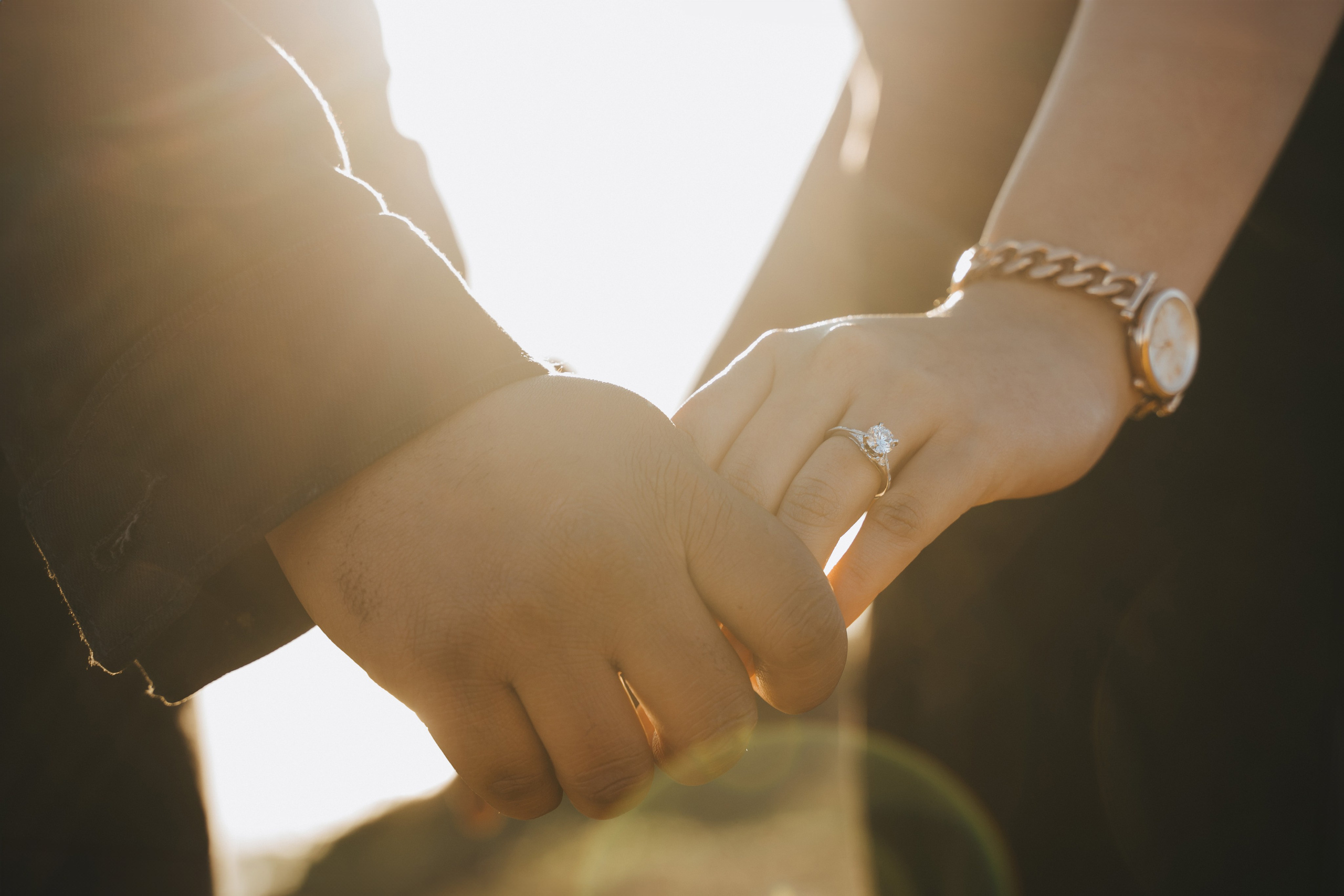 Proposal.  Overlooking the golden San Franisco Bridge sunset with a couple. Photographer Video. 