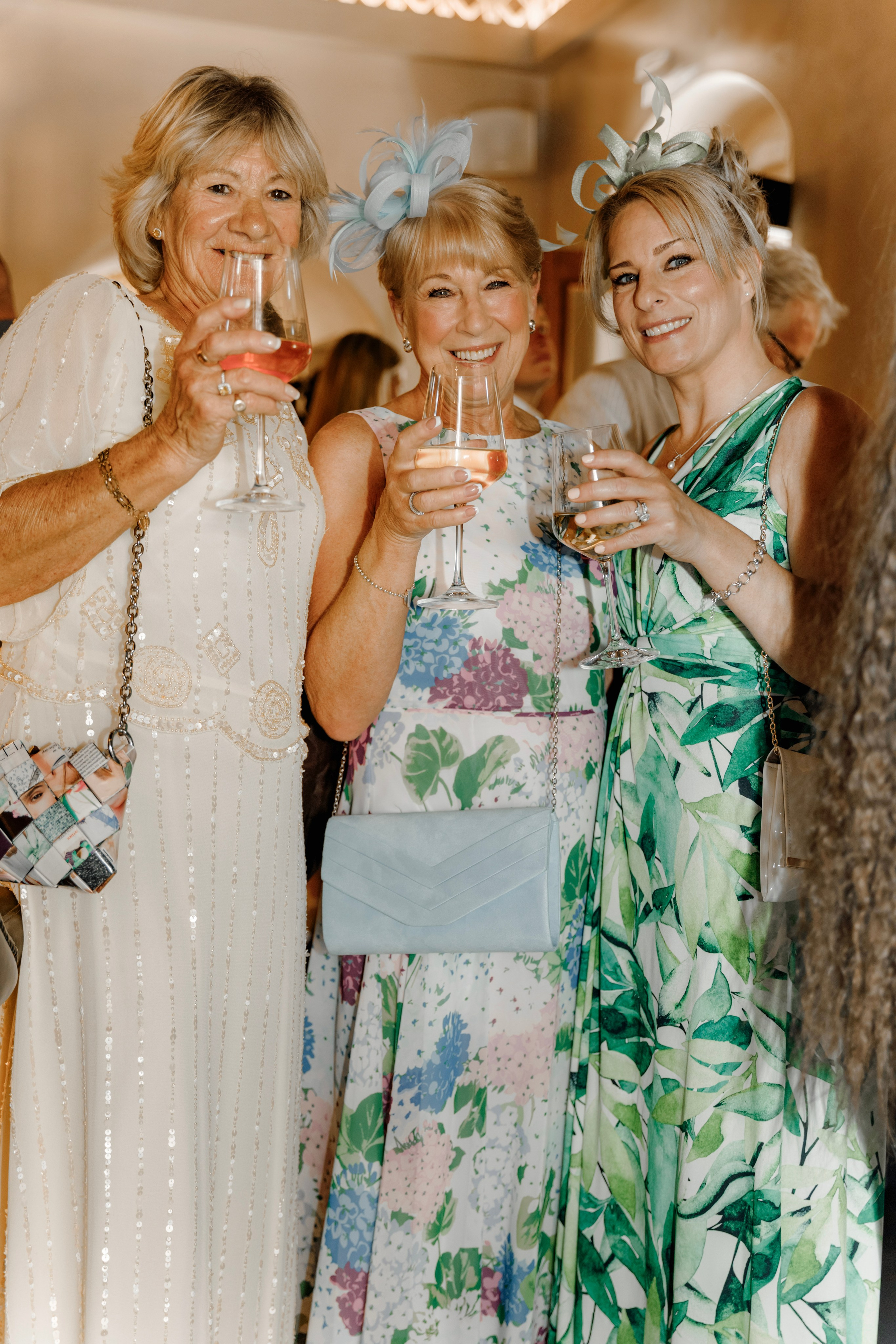 Group of friends enjoying drinks and sharing stories at a pre-wedding party in a charming Lindos bar