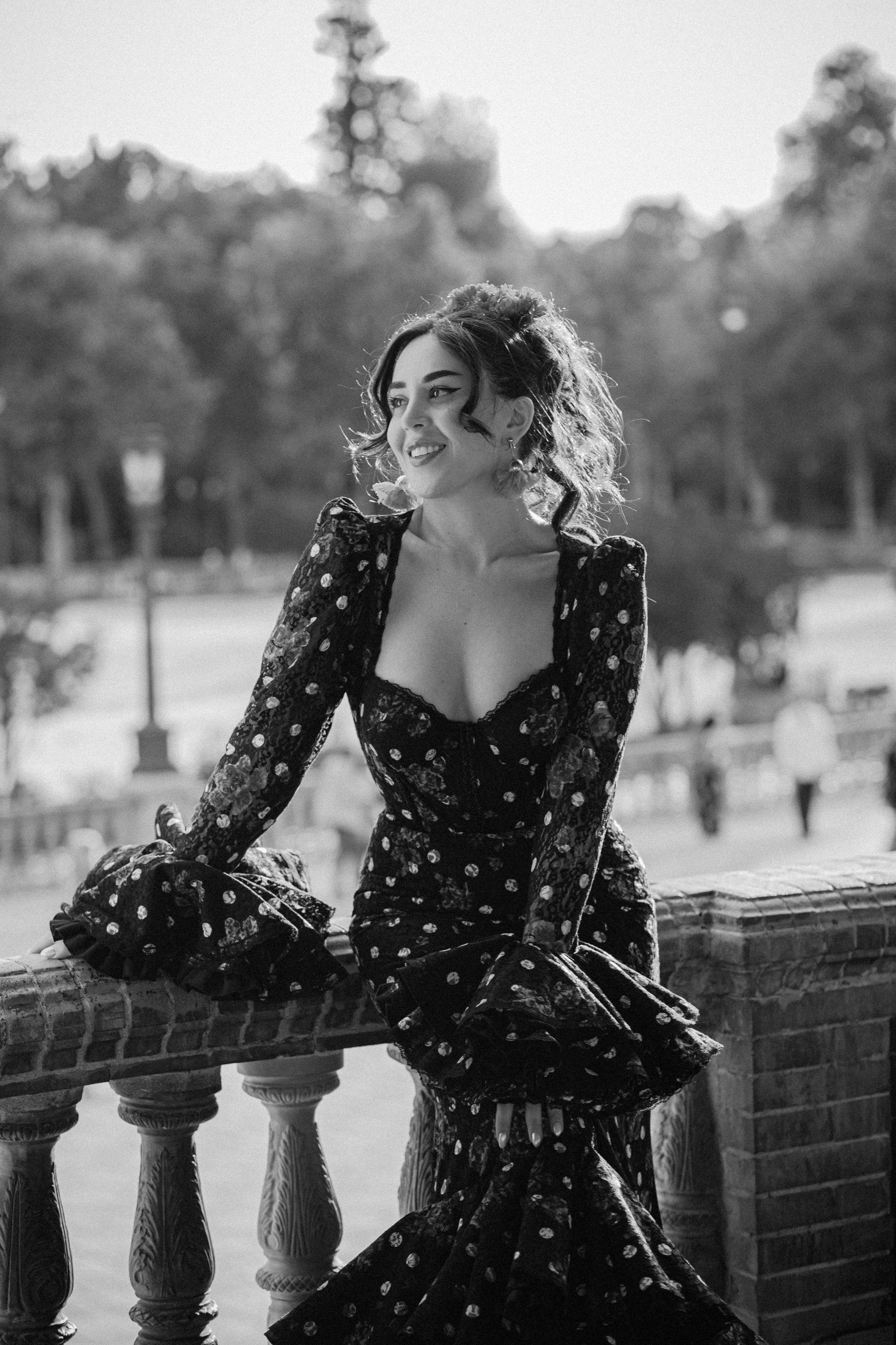 Элегантный чёрно-белый портрет женщины в традиционном платье фламенко на площади Испании в Севилье, Испания — идеально для демонстрации вечной и художественной портретной съёмки в Севилье и южной Испании.