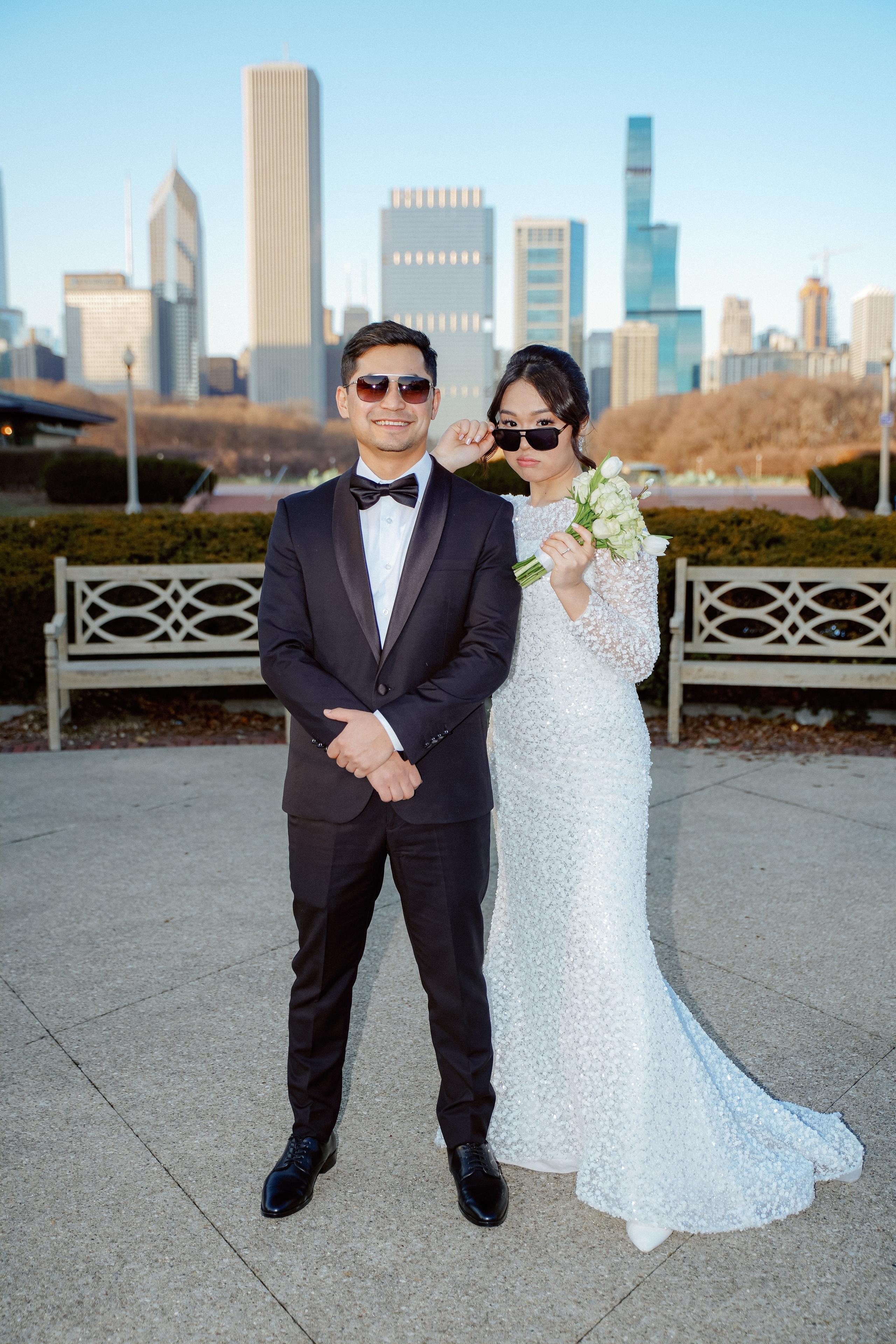 Bride and groom wedding portrait at Millennium Park Chicago with downtown skyline view and romantic city atmosphere.
