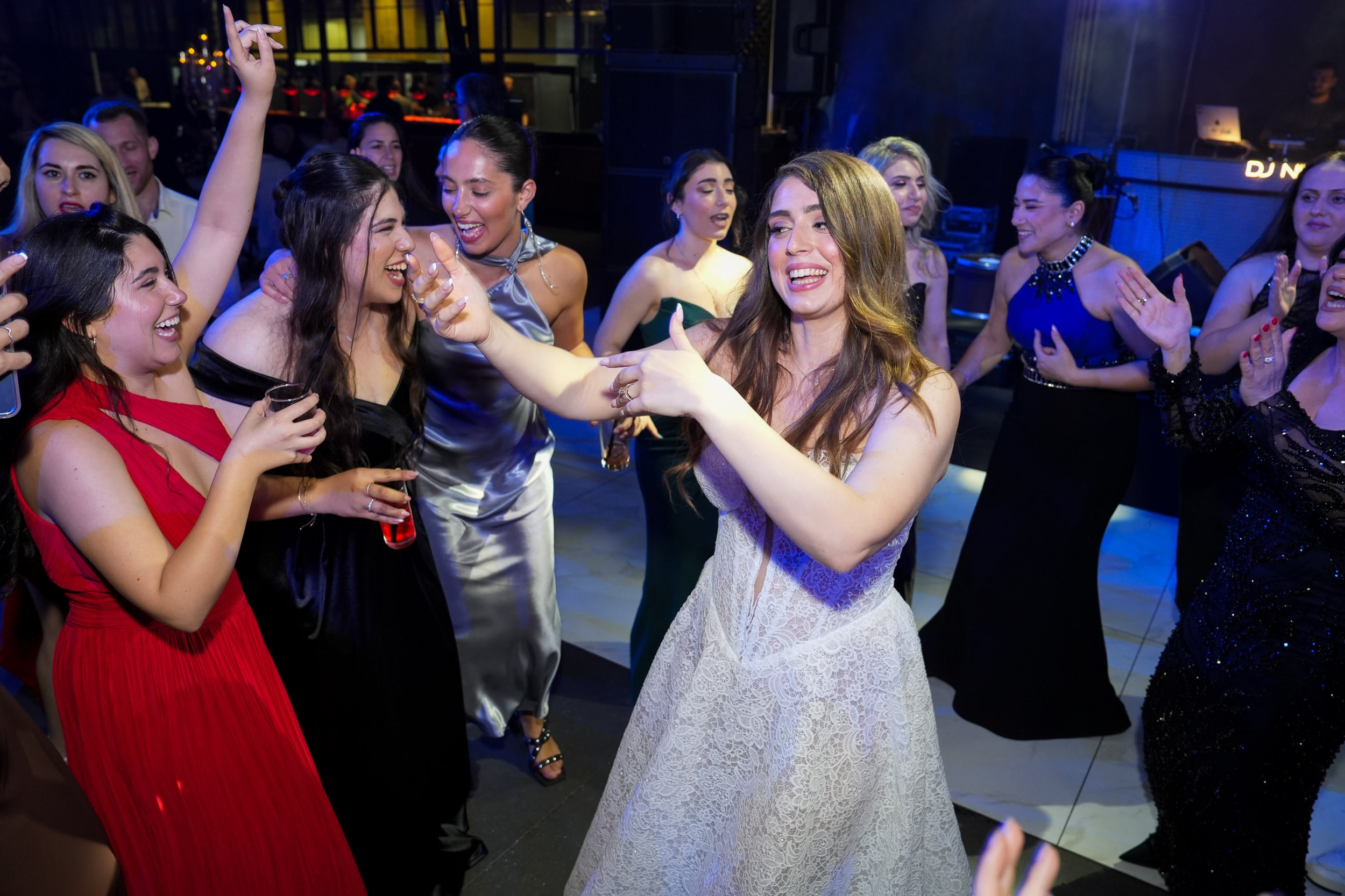 Bride Tzipi laughing and dancing with her bridesmaids and guests at 88 Event Garden in Emek Hefer, Israel