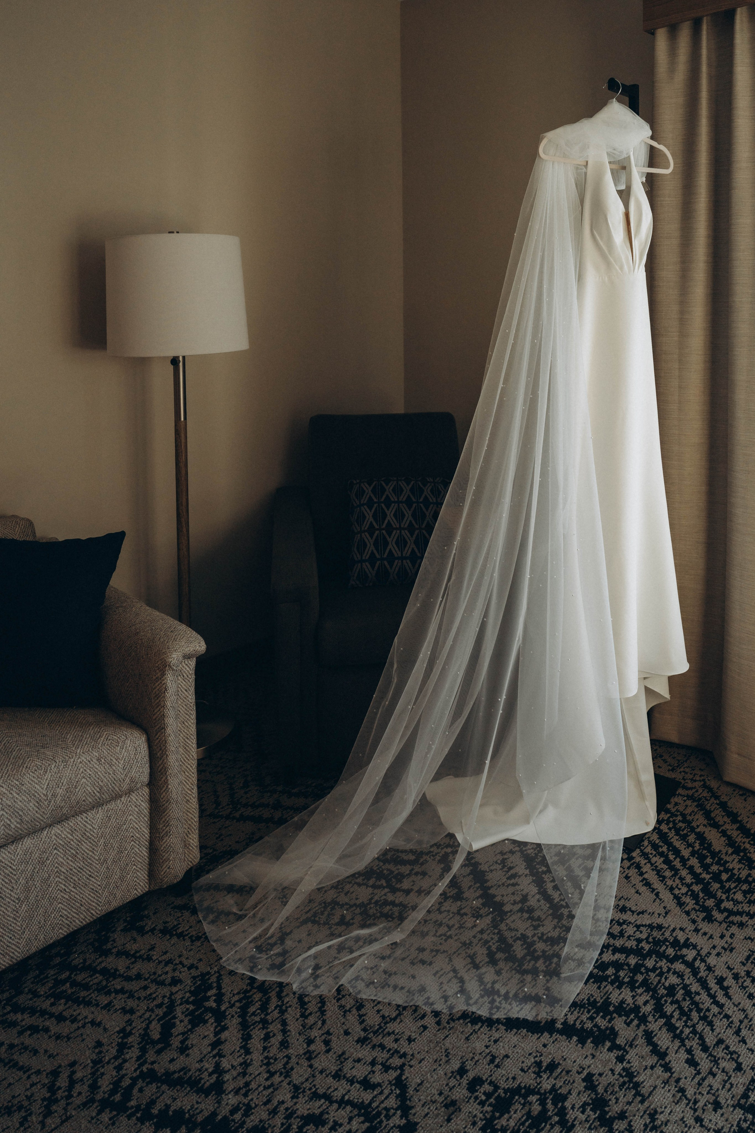 Bride sitting on bench in Saratoga Springs gardens.