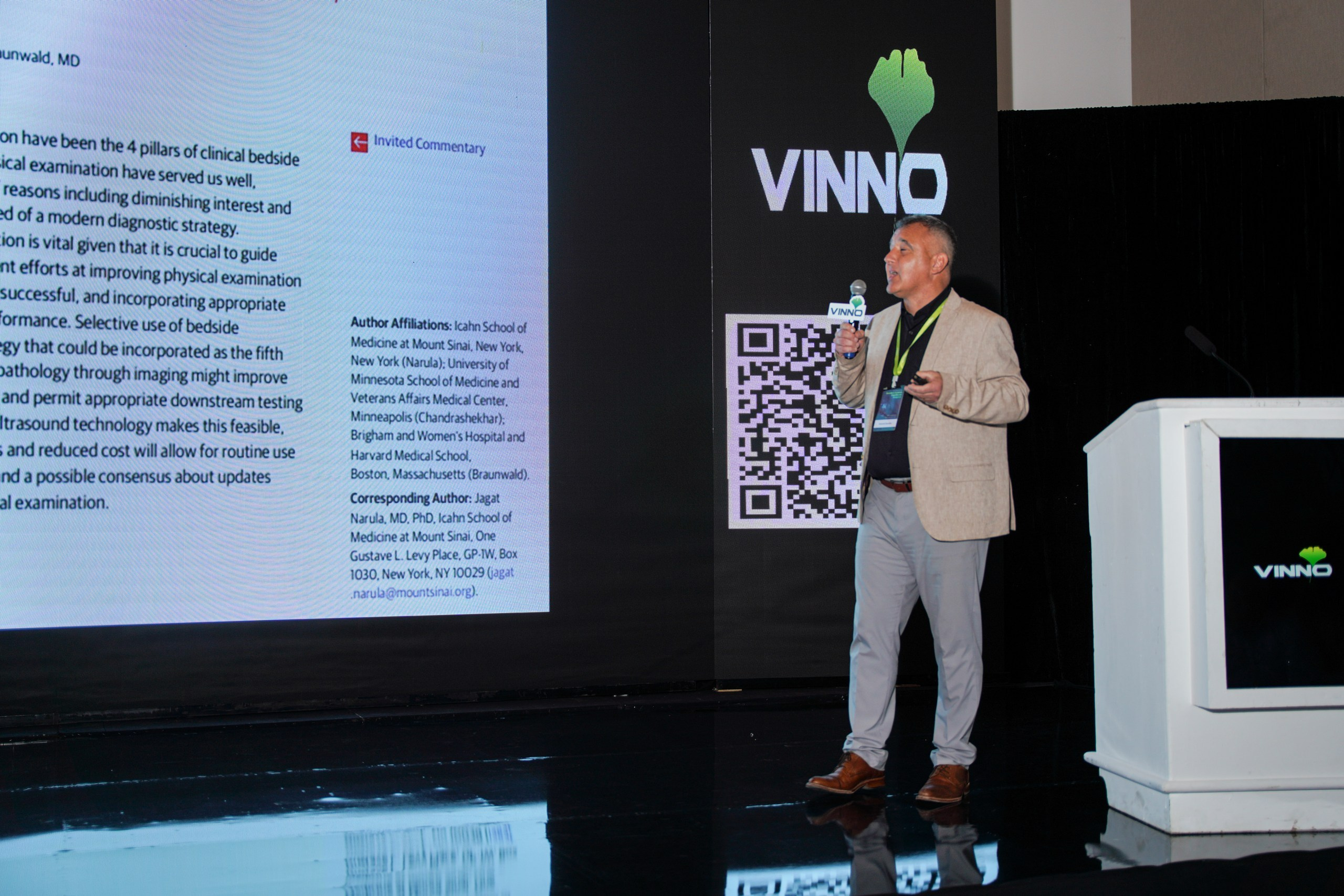 Company workforce listening to a stage presentation about business strategies.