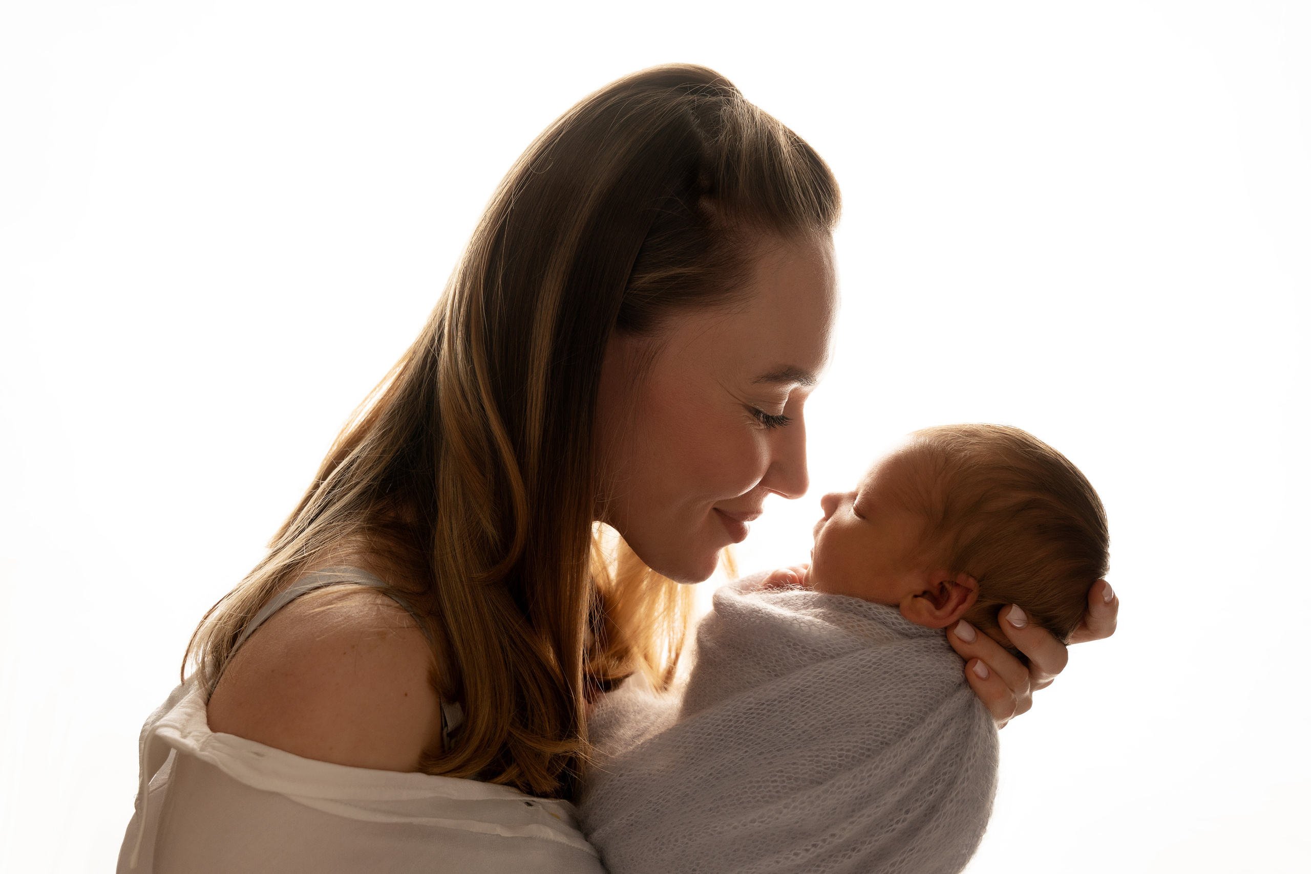 Eine junge Mama, die ihr kleines Wunder bewundert