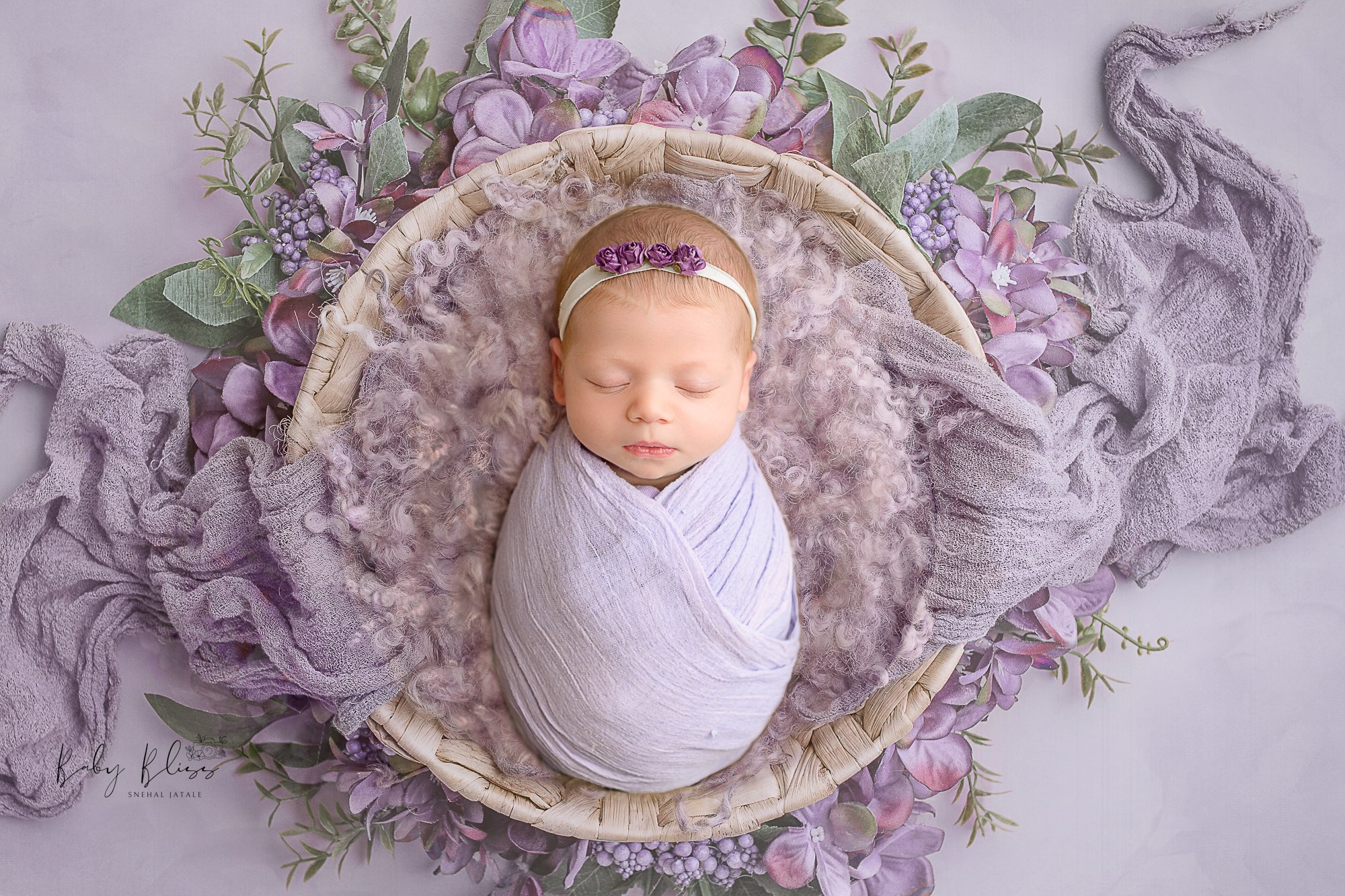lavender colour wrapped newborn baby girl with beautiful digital background.